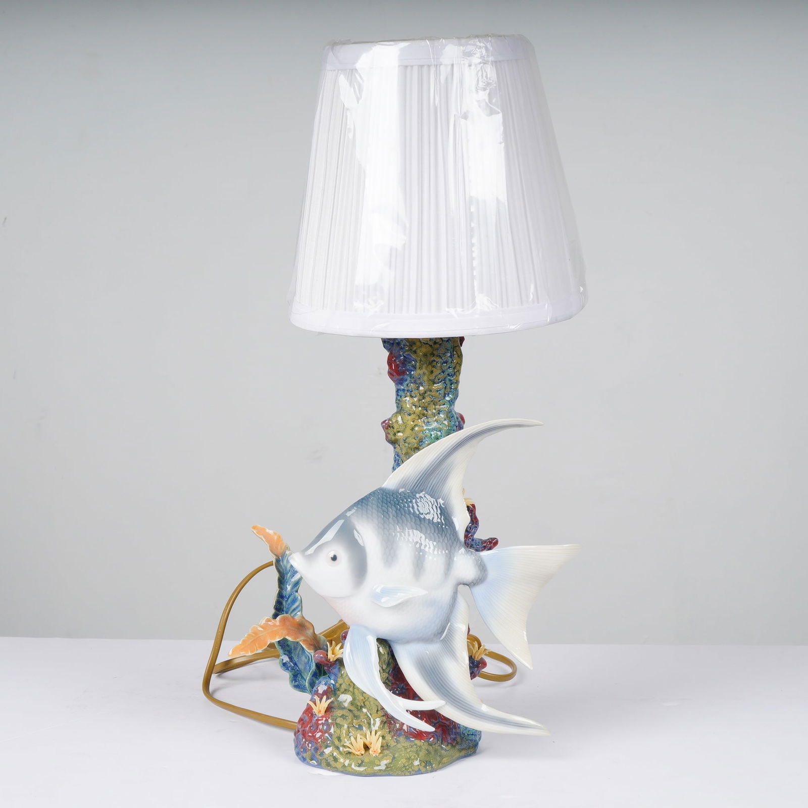 Lladro Table Lamp Underwater Explorer Nautical Style: This Lladro porcelain table lamp, officially titled Underwater Explorer (model 1006762), features a masterfully sculpted base depicting a large angelfish navigating a vibrant coral reef. The
