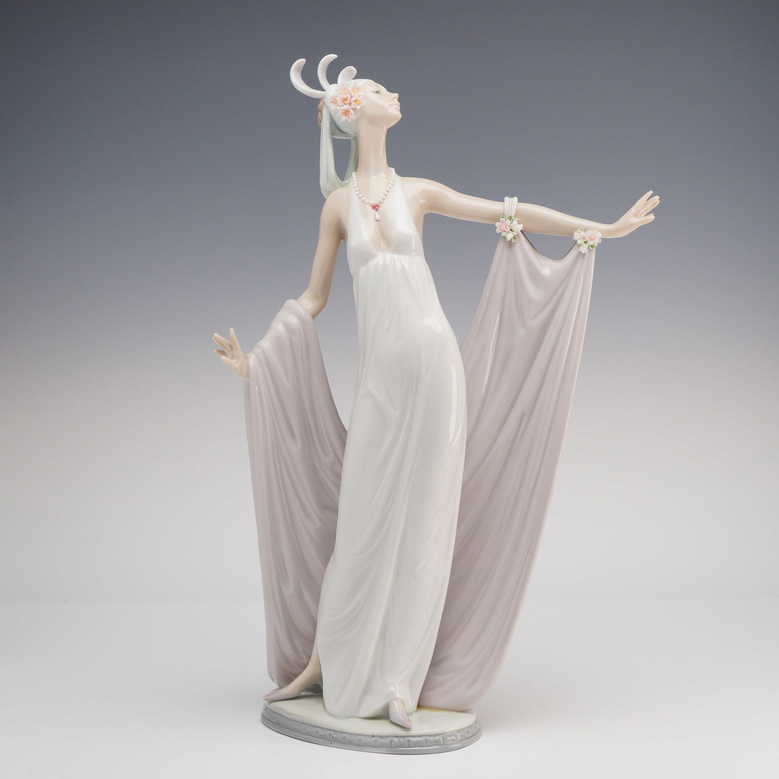 Lladro Grand Dame Porcelain Figurine: This elegant Lladro polychrome glazed porcelain figurine, titled Grand Dame, depicts a slender woman in a graceful Art Deco-inspired pose. She is dressed in a flowing white evening gown with a