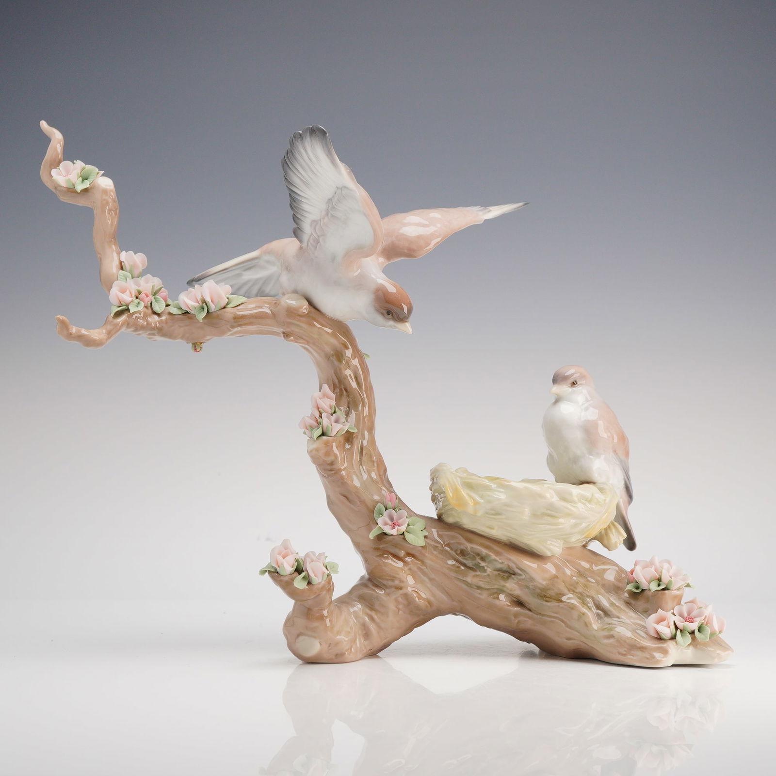 Lladro Spring's New Arrivals Limited Edition Porcelain Figurine: A large and intricate Lladro glazed porcelain sculpture titled "Spring's New Arrivals" (model number 1854), also known by the Spanish title "El canto de los Pájaros." This naturalistic scene depicts