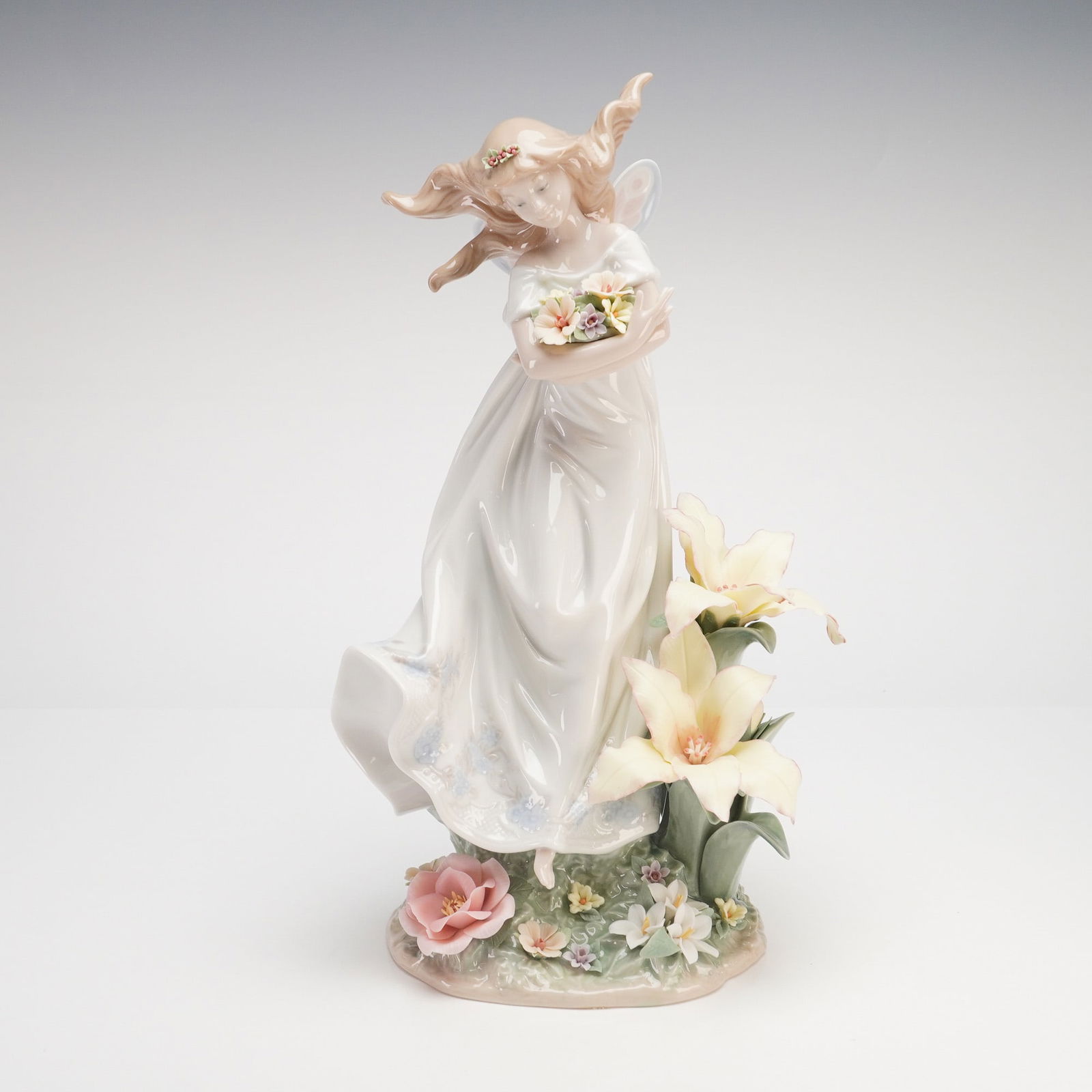 Lladro Mystical Garden Porcelain Figurine Model 6686: A large and intricate Lladro glossy sculpture model 6686, titled Mystical Garden. This celestial figure is depicted as a winged fairy in a graceful, wind-swept pose, wearing a flowing white gown and