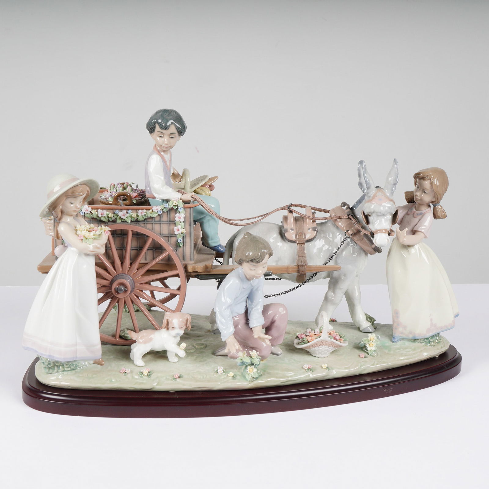 Lladro Porcelain Sculpture Enchanted Outing 1001797: A large and intricate Lladro fine porcelain figurine titled Enchanted Outing, model number 1001797. This pastoral tableau features four children and two animals in a highly detailed scene. A boy sits