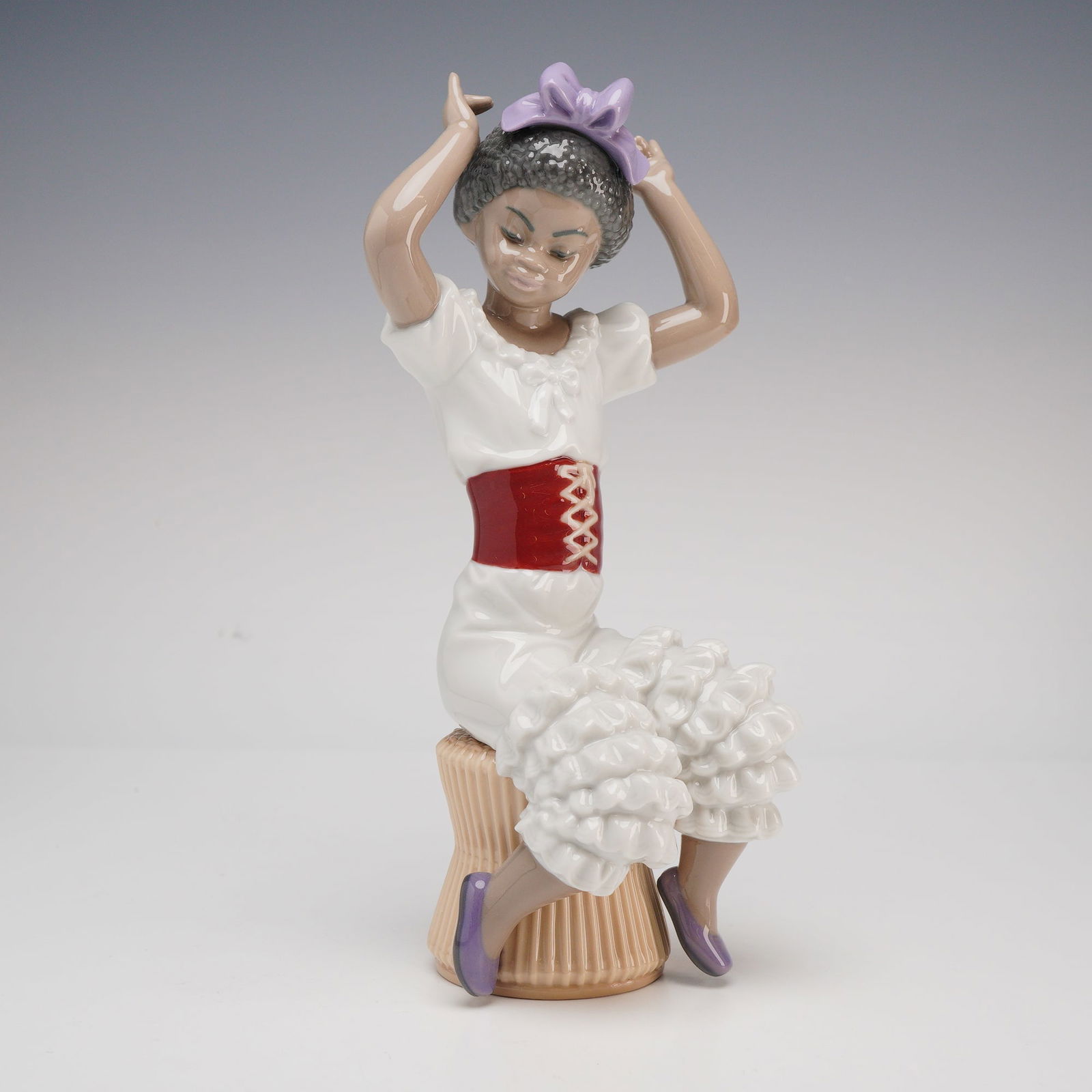 Lladro Caribe Exclusive Thinking of My Debut (Model 5483): This fine porcelain figurine is produced by the renowned Spanish manufacturer Lladro as part of the Caribe collection, an exclusive series originally distributed through duty-free retailers in the