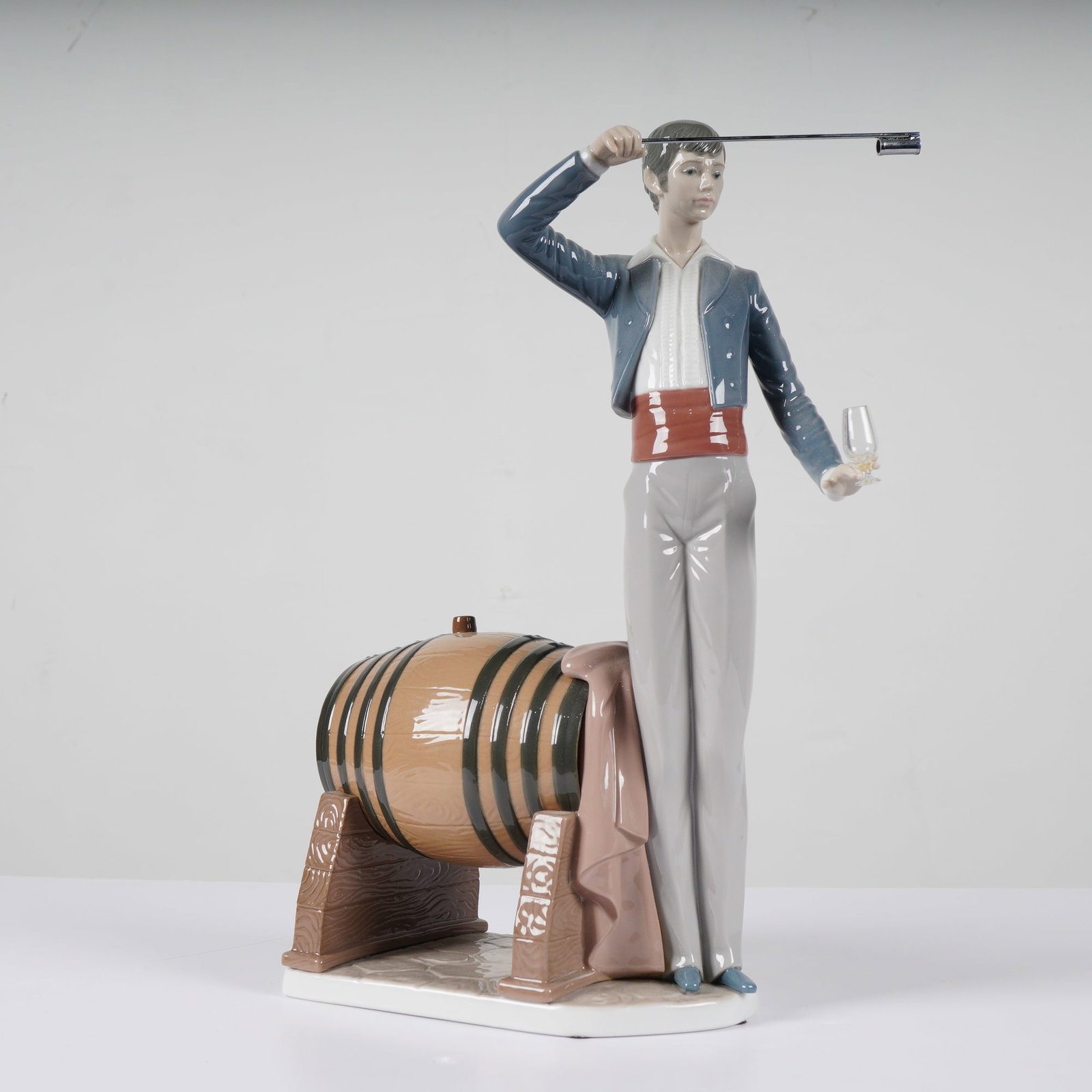 Lladro The Wine Taster (El Venenciador) Figurine 1005239: Lladro glazed porcelain figurine titled The Wine Taster (El Venenciador), model number 1005239 (incised 5239). Designed by sculptor Salvador Furio, the piece depicts a young man in traditional