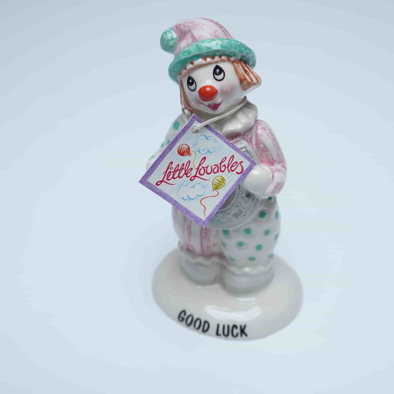 Beswick Little Lovables Figurine, Good Luck: Charming Beswick porcelain figurine from the Little Lovables collection. This delightful hand painted figure showcases a cheerful clown dressed in a pink and white patterned costume with green accents