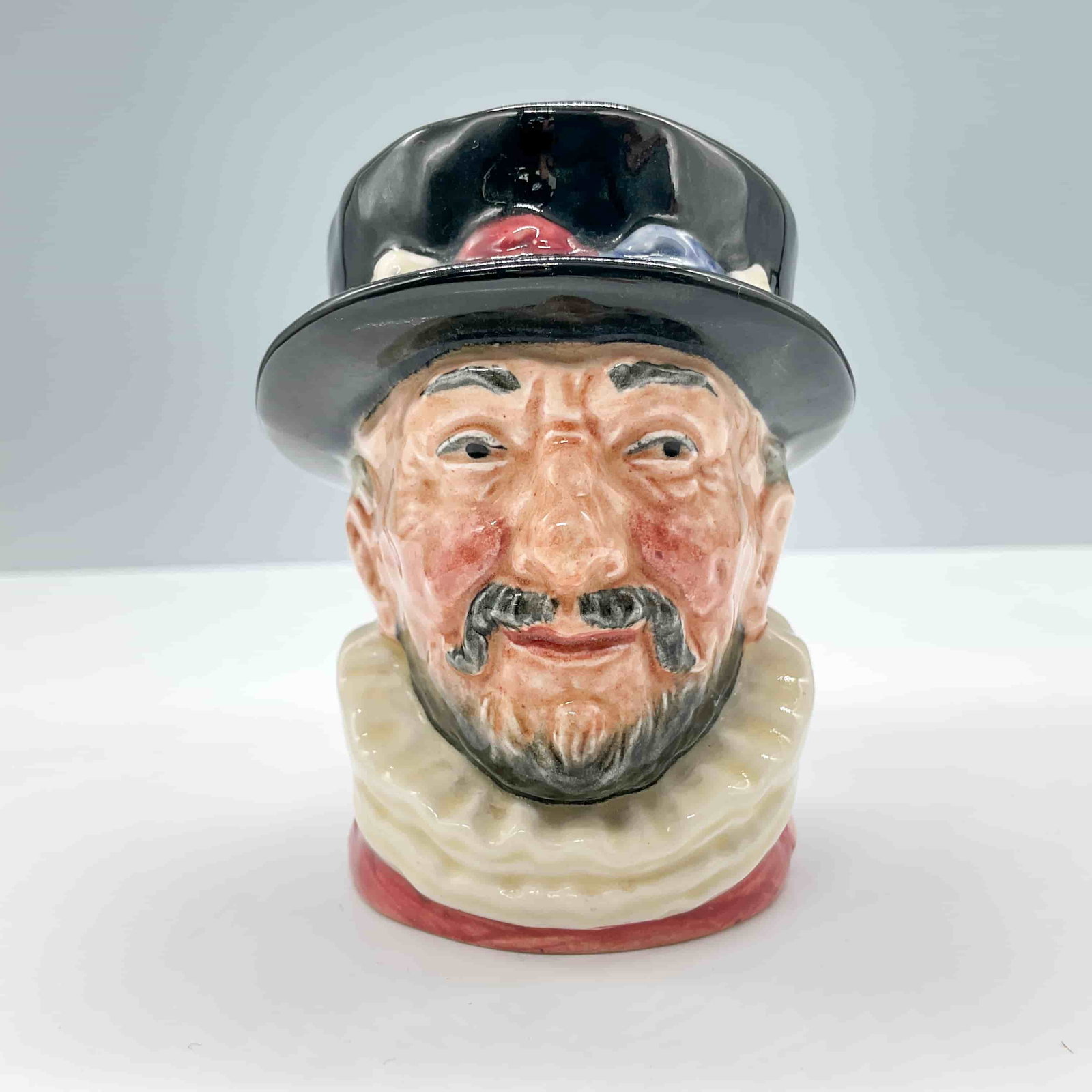Beefeater ER D6233 - Small - Royal Doulton Character Jug: Variation Three. Pink coloration with ER cipher handle. Royal Doulton backstamp. ArtistHarry Fenton Dimensions3.25"H Date or Era1953 - 1987 Manufacturer or BrandRoyal Doulton Country of OriginEngl