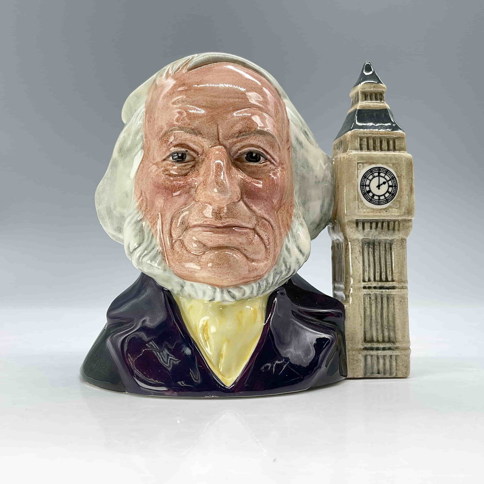 John Doulton D6656 - Small - Royal Doulton Character Jug: Marked John Doulton 1793-1873 to bottom base. Big Ben is at Two O'clock. Dark purple coat with lemon cravat; Big Ben is light brown. To honor John Doulton, the Royal Doulton International Collectors C