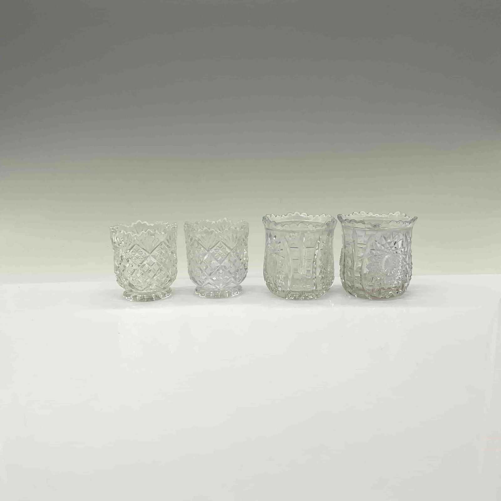 4pc Early Pattern Glass Toothpick Holders: This grouping includes two matching sets one with oval starts and the other with diamond patterns. The largest piece measures 2.5"H x 2.25" dia. DimensionsSee Description Date or Era20th century