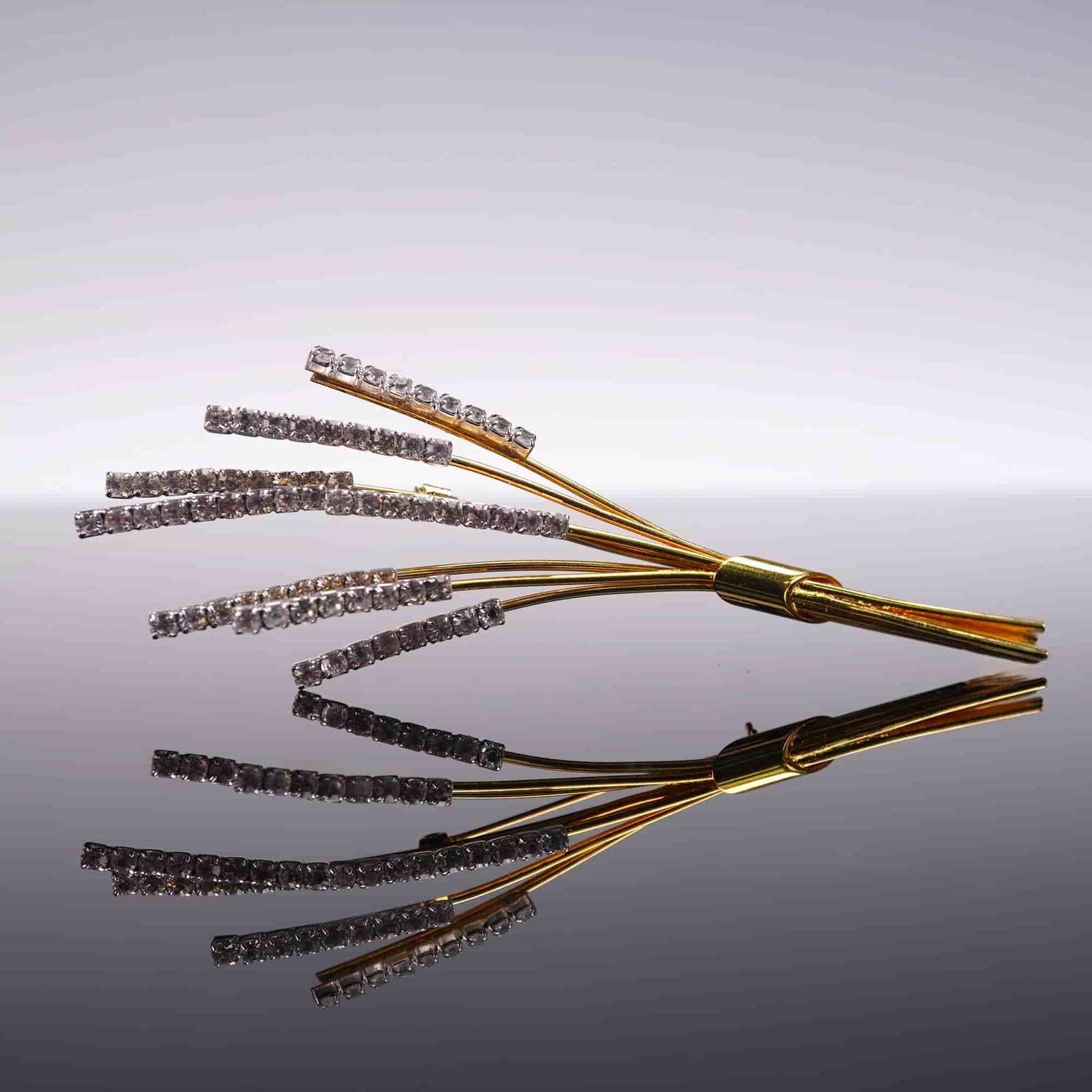 Gold-tone Rhinestone Wheat Brooch with Cattails: Vintage gold-tone brooch designed in the form of a stylized wheat bouquet or cattail cluster, accented with clear rhinestones. The brooch features a sweeping, organic arrangement of slender stems and