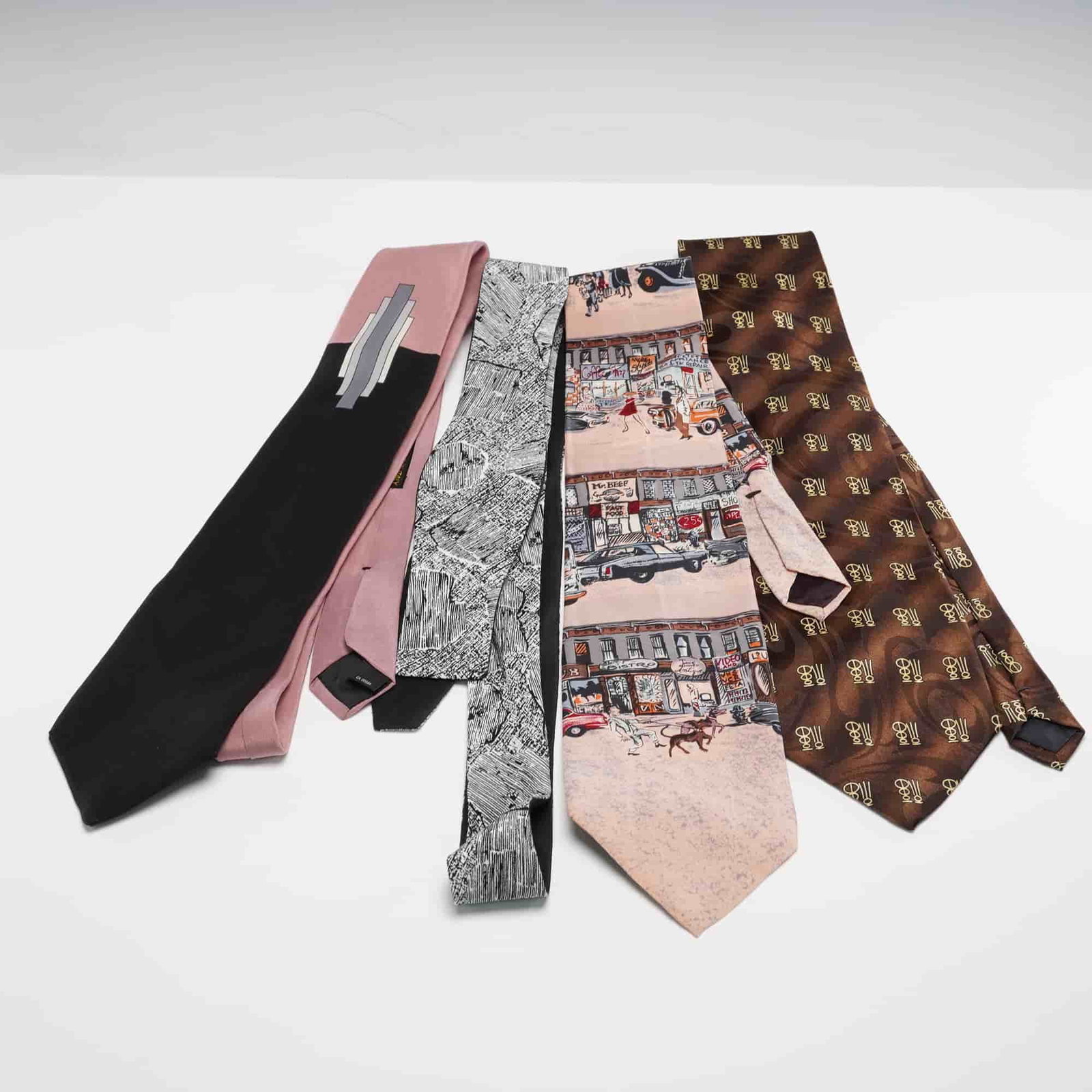 4pc Necktie and Bow Tie Set, Marek, Gold City, Liberty of London, Moeb: A four piece set featuring a Marek necktie with a pink and black abstract design, a Gold City necktie in brown with a repeating gold emblem pattern, a Liberty of London necktie with a detailed city