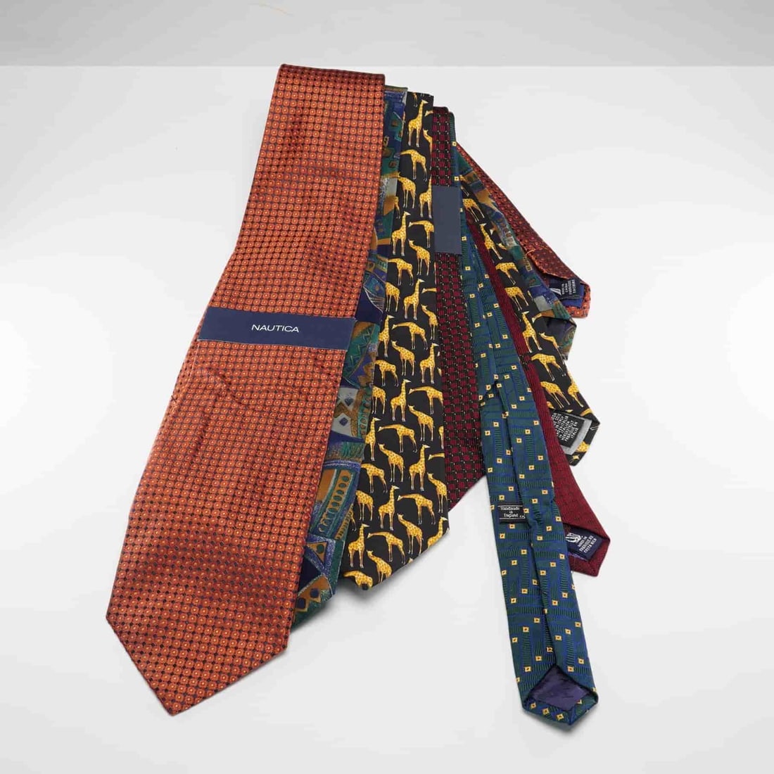 5pc Necktie Collection, Nautica, Pink, Geoffrey Beene, Beaufort: A five-piece necktie collection featuring a variety of patterns and designers, including two Nautica ties with distinctive geometric motifs, a Pink tie showcasing a bold blue and green geometric