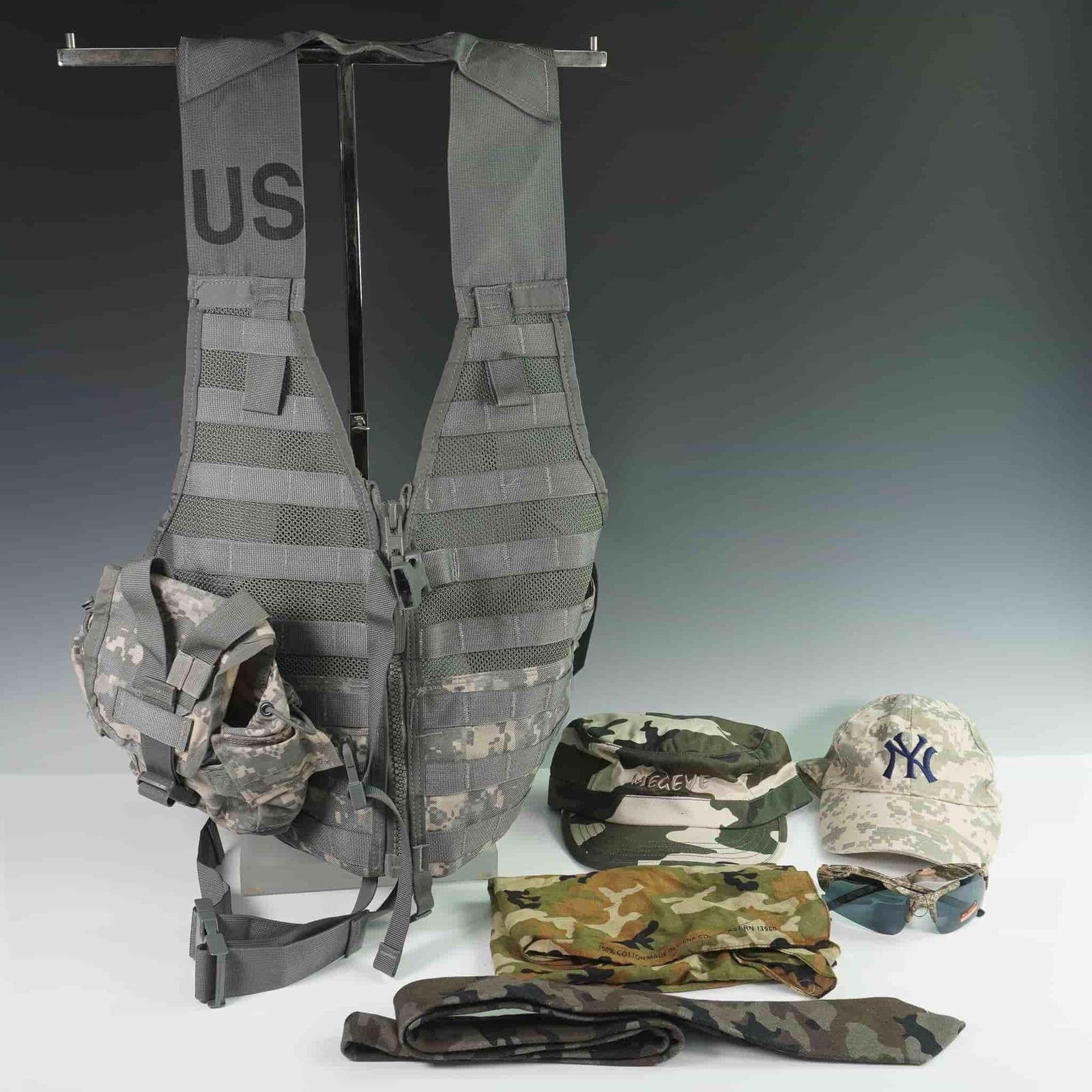 6pc Camouflage and Tactical Gear Accessory Set: Collection of six military-style and fashion accessories, including a tactical MOLLE vest marked "US" with mesh paneling and strap webbing, featuring an attached ACU digital camouflage utility pouch.