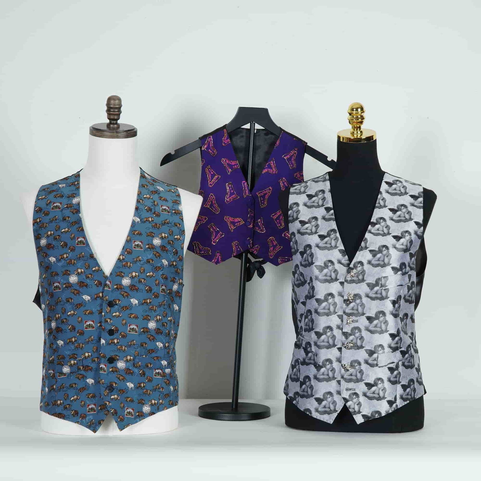 3pc Silk Patterned Vests by Nicole Miller and Tom Gilbey: A group of three patterned waistcoats comprising two adult examples and one child's size, including a Nicole Miller men's vest of 100% silk with a blue ground decorated with whimsical animal motifs,