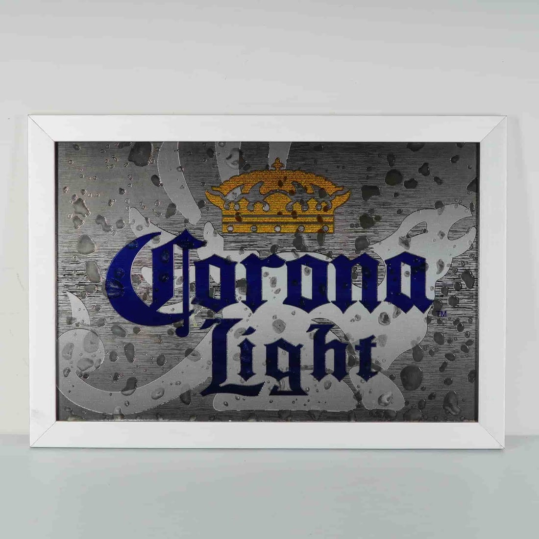 Corona Light Beer Advertising Mirror with White Frame: A vibrant and eye-catching Corona Light advertising mirror, perfect for collectors of breweriana or vintage bar decor. The design features the iconic Corona Light logo in bold blue Gothic lettering,