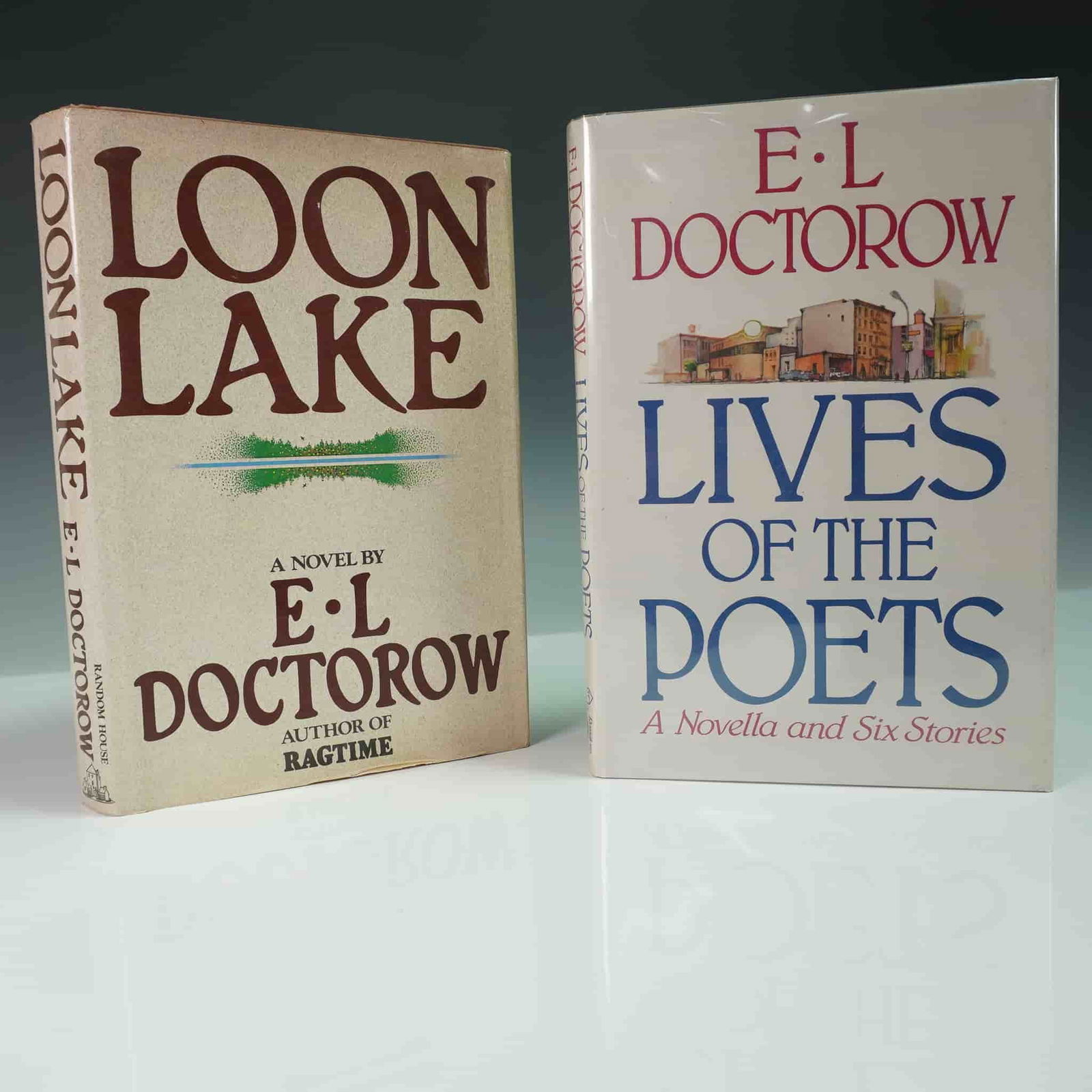 2 E.L. Doctorow, Loon Lake & Lives of the Poets: This two-piece lot features first edition books by acclaimed American author E.L. Doctorow. Included are Loon Lake (1980) and Lives of the Poets (1984), both published by Random House. Loon Lake is a