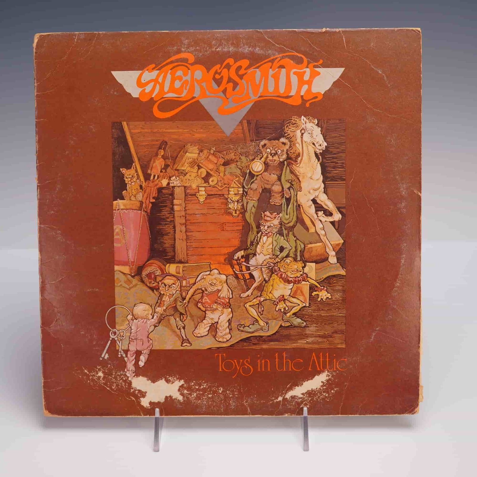 Aerosmith Toys in the Attic LP Columbia: Aerosmith LP record titled Toys in the Attic, Columbia label PC 33479 with matrix PAL 33479-1G etched in runout. Classic rock album featuring tracks such as Walk This Way and Sweet Emotion. Measures 1