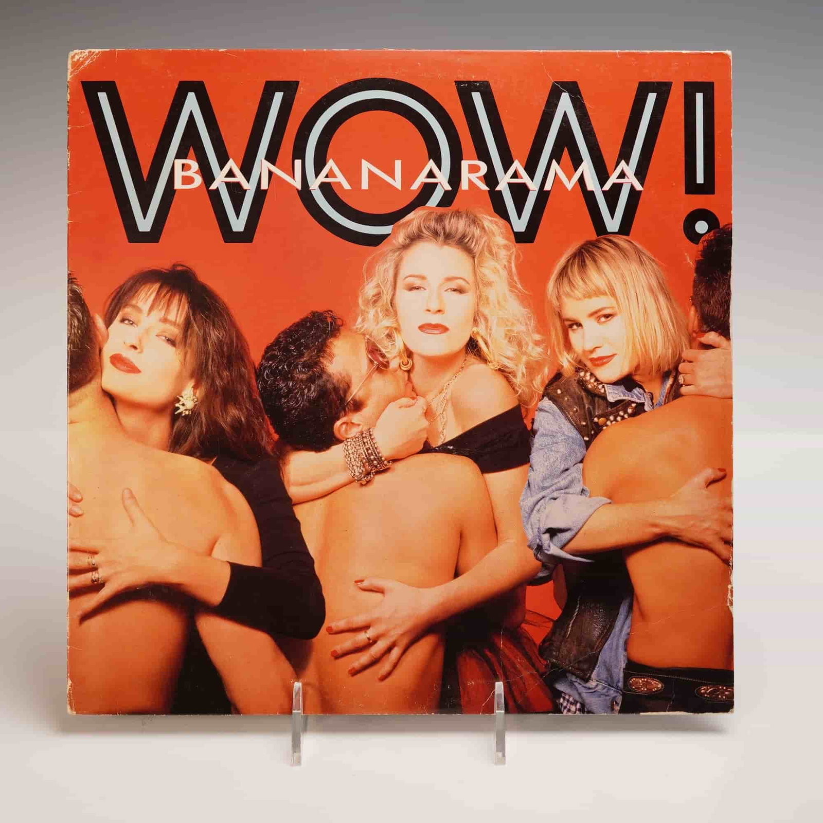 Bananarama Vinyl Record, Wow!: A sizzling vinyl of Bananaramas Wow, pressed on black vinyl with a sharp cream London label, wrapped in a fiery red cover showing the trio embraced by shirtless men in bold glamorous poses, the back c