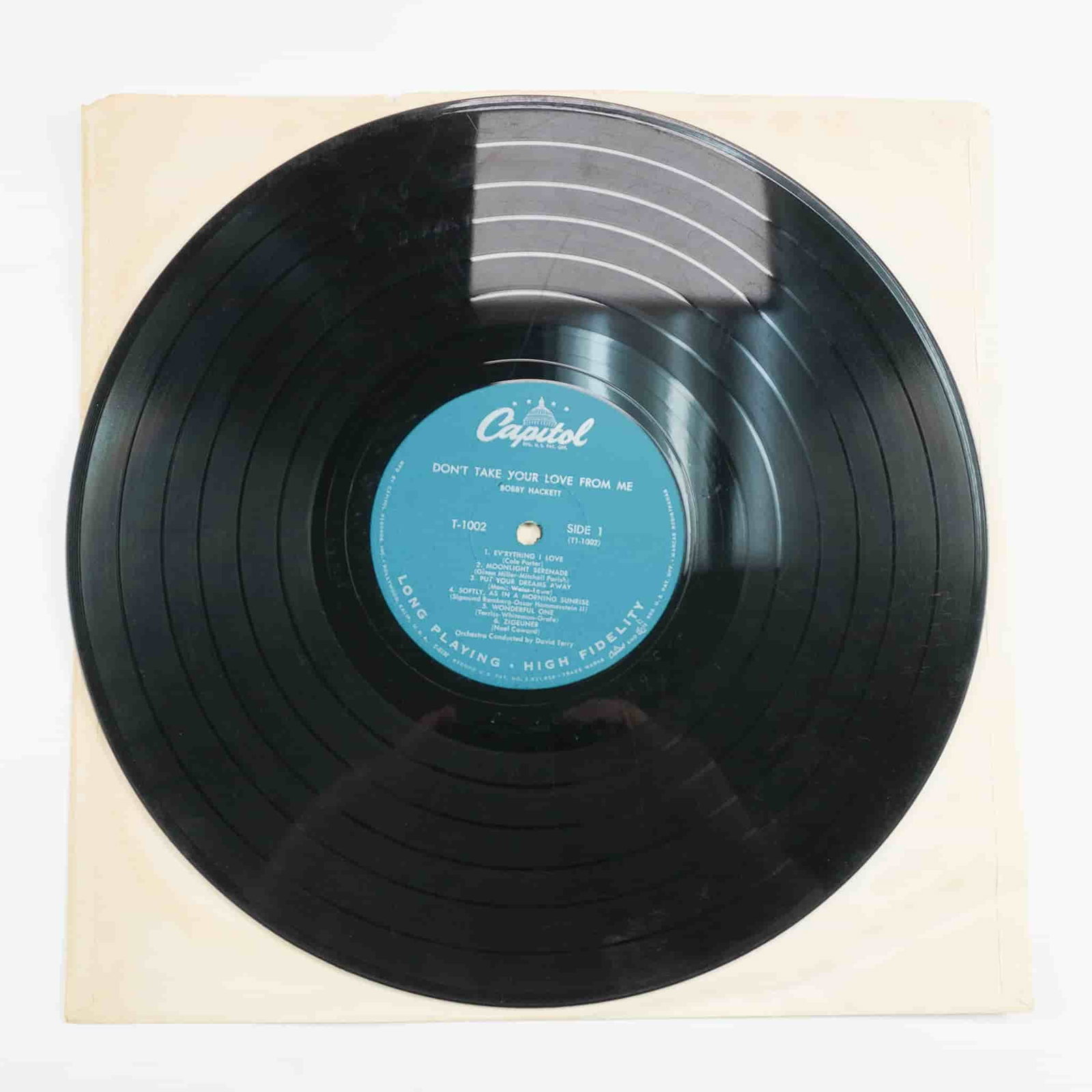 Bobby Hackett Vinyl Record, Don't Take Your Love From Me: Released under Capitol Records, this vinyl record features Hackett's trumpet performance in an easy listening style, delivering a collection of smooth jazz interpretations. The album contains arrangem