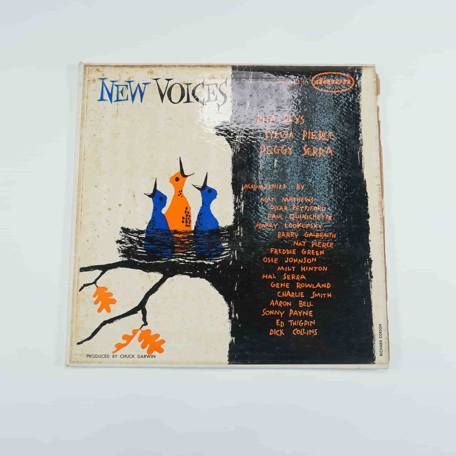 Dawn Records New Voices LP - DLP 1125: Dawn Records presents New Voices, an LP featuring vocal performances by Rita Reys, Sylvia Pierce, and Peggy Serra. Accompanied by renowned jazz musicians such as Mat Mathews, Oscar Pettiford, Paul Qui
