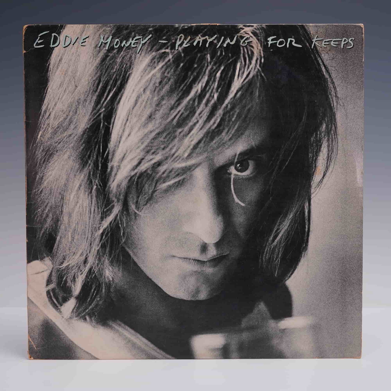 Eddie Money LP Record - Playing for Keeps: American rock singer and songwriter Eddie Money, known for his raspy vocals and radio-friendly blend of rock and pop, rose to prominence in the late 1970s and 1980s with a string of chart-topping hits