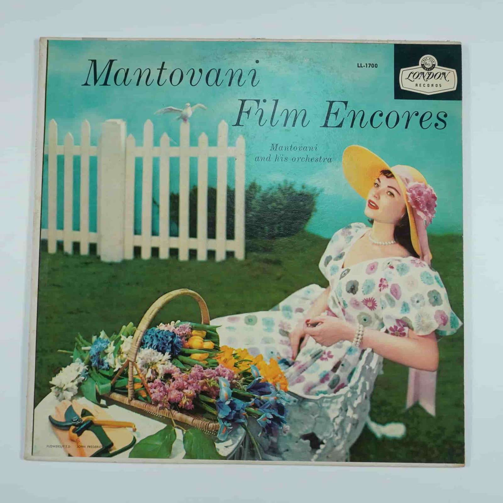 London Records Vinyl Record, Mantovani Film Encores: This vintage vinyl record, Mantovani Film Encores, was released by London Records and features Mantovani and His Orchestra performing orchestral renditions of famous film scores. The album includes cl
