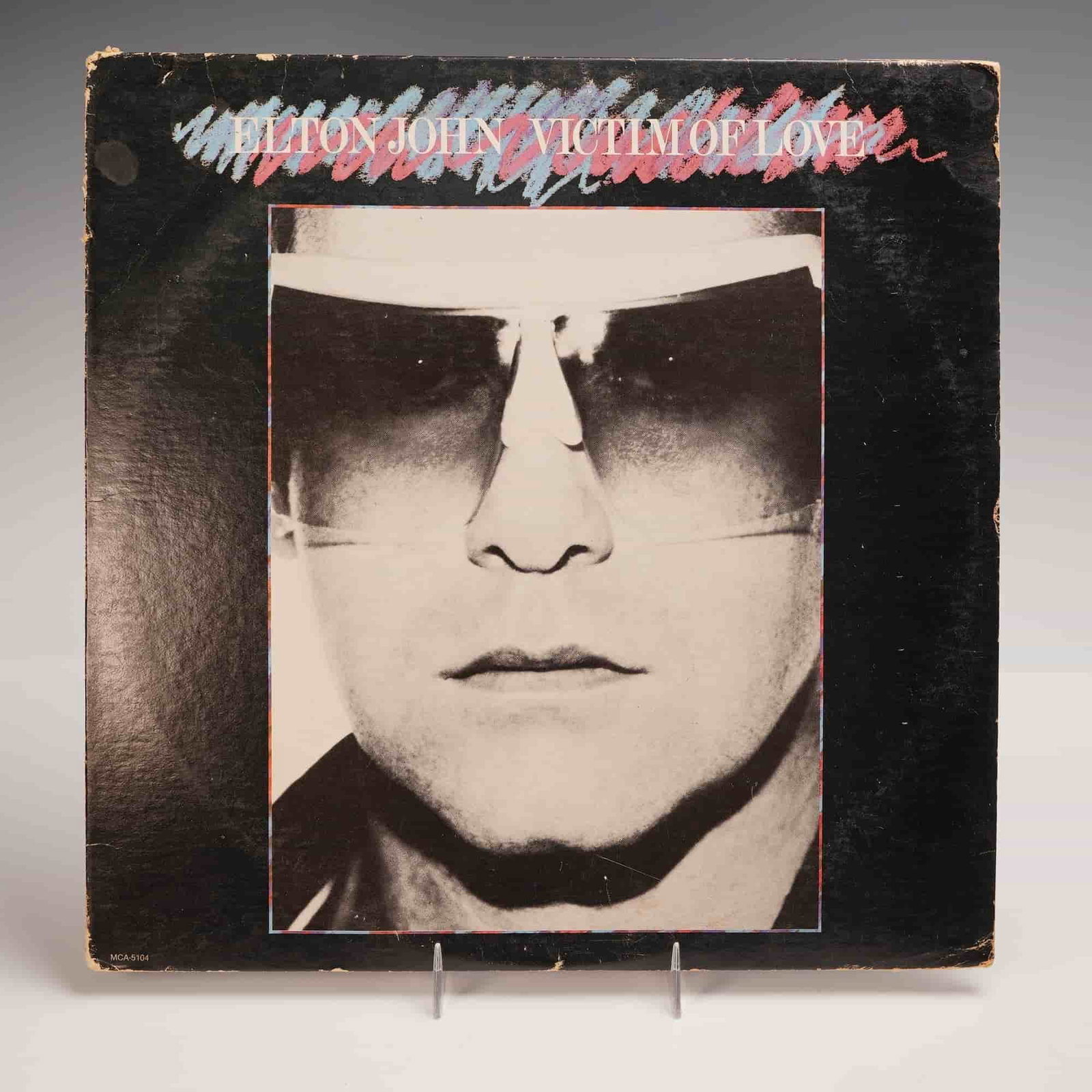 MCA Records Elton John Vinyl Record, Victim of Love: A 1979 MCA Records stereo pressing of Elton John's "Victim of Love," representing a distinct foray into disco era stylings. Produced by Pete Bellotte and arranged by Thor Baldursson. This album featur