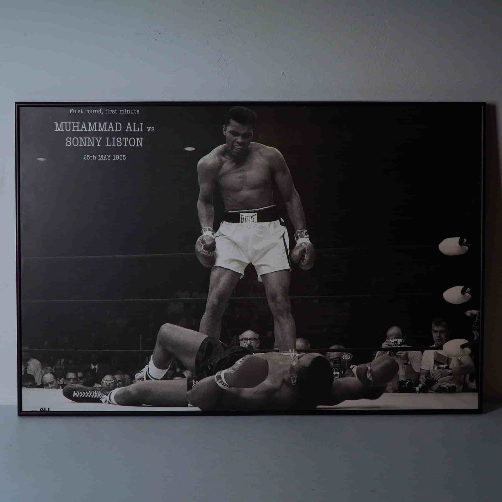 Muhammad Ali vs Sonny Liston Fight Phantom Punch Poster on Board: An electrifying framed photo poster mounted on board, capturing one of the most famous moments in sports history, Muhammad Ali standing triumphantly over Sonny Liston after the first-round knockout on