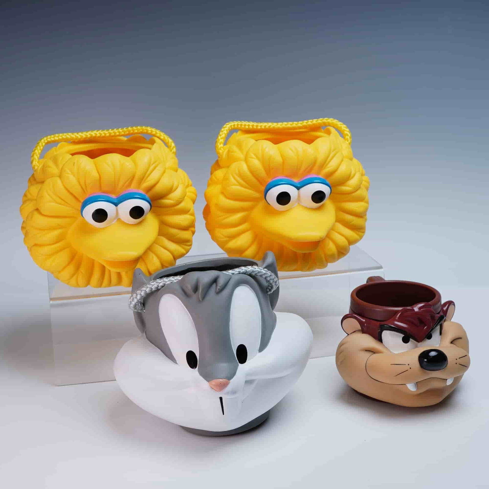 4pc Vintage Plastic Mug and Buckets Featuring Looney Tunes and Sesame St: This is a delightful set of four vintage character-themed plastic vessels featuring beloved figures from Looney Tunes and Sesame Street. Included are two matching Big Bird candy buckets, one Bugs Bunn