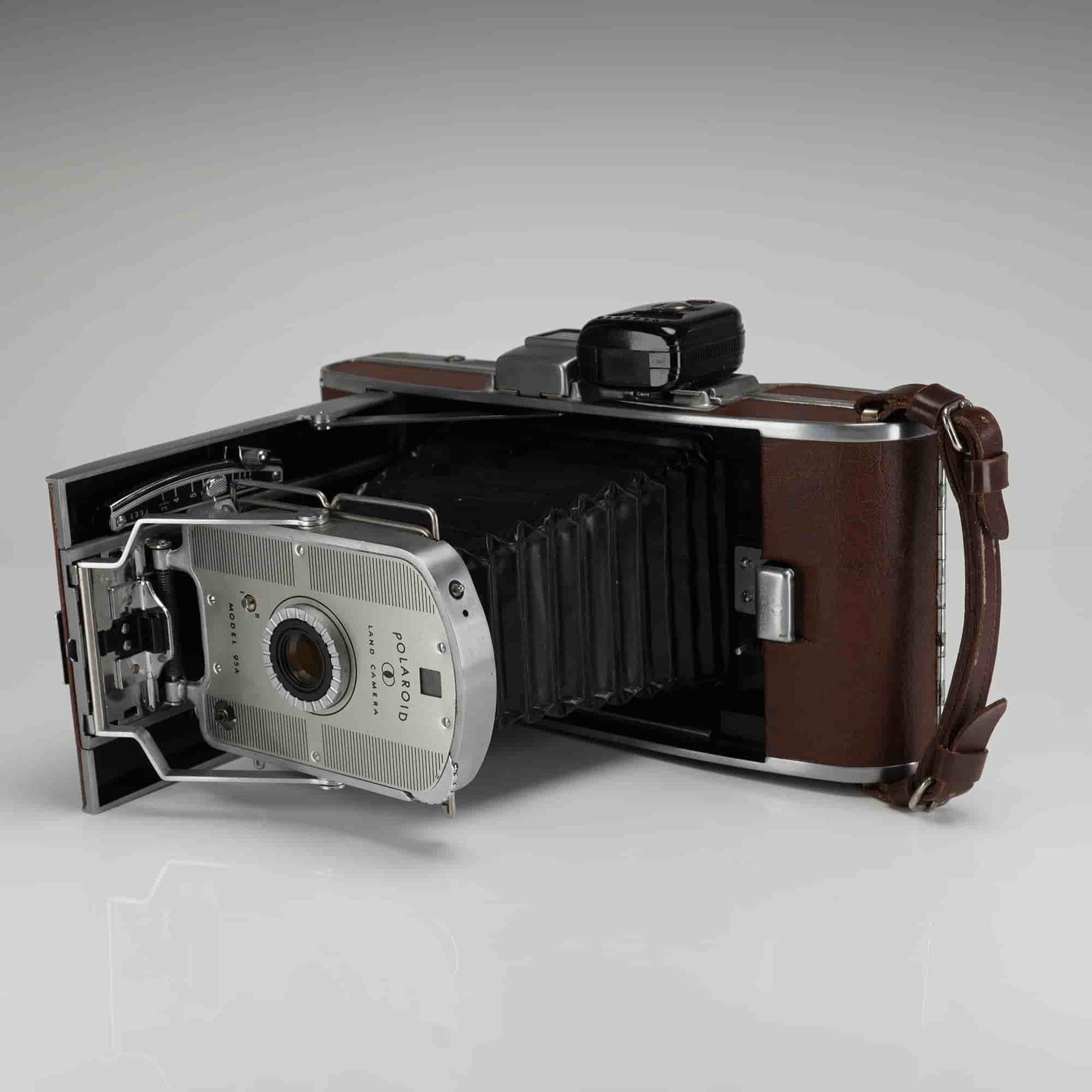 Polaroid Model 95A Land Camera: A vintage Polaroid Land Camera, Model 95A. This camera belongs to the original Land Camera series, which was the first commercially produced instant camera, manufactured starting in 1948. The folding