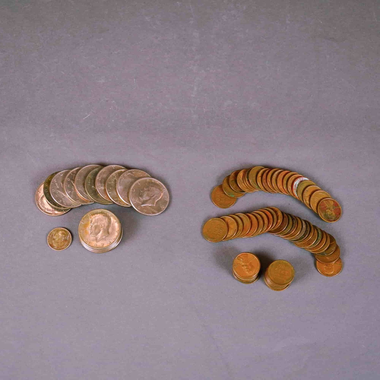 1957-1973 US Lincoln Memorial Cent and Kennedy Half Dollar Collection: A group of coins comprising Kennedy half dollars and Lincoln Memorial one cent coins. The collection includes examples dated 1973 for the half dollars and 1957 for the cents. A Denver mint mark (D)
