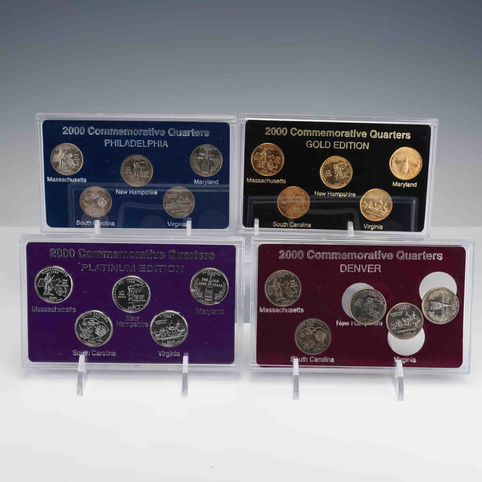 4pc 2000 Commemorative Quarter Sets: Four 2000 Commemorative Quarter sets issued as part of the 50 States Quarter Program, each housed in a clear acrylic display holder with its original decorative box. The collection includes the Gold E