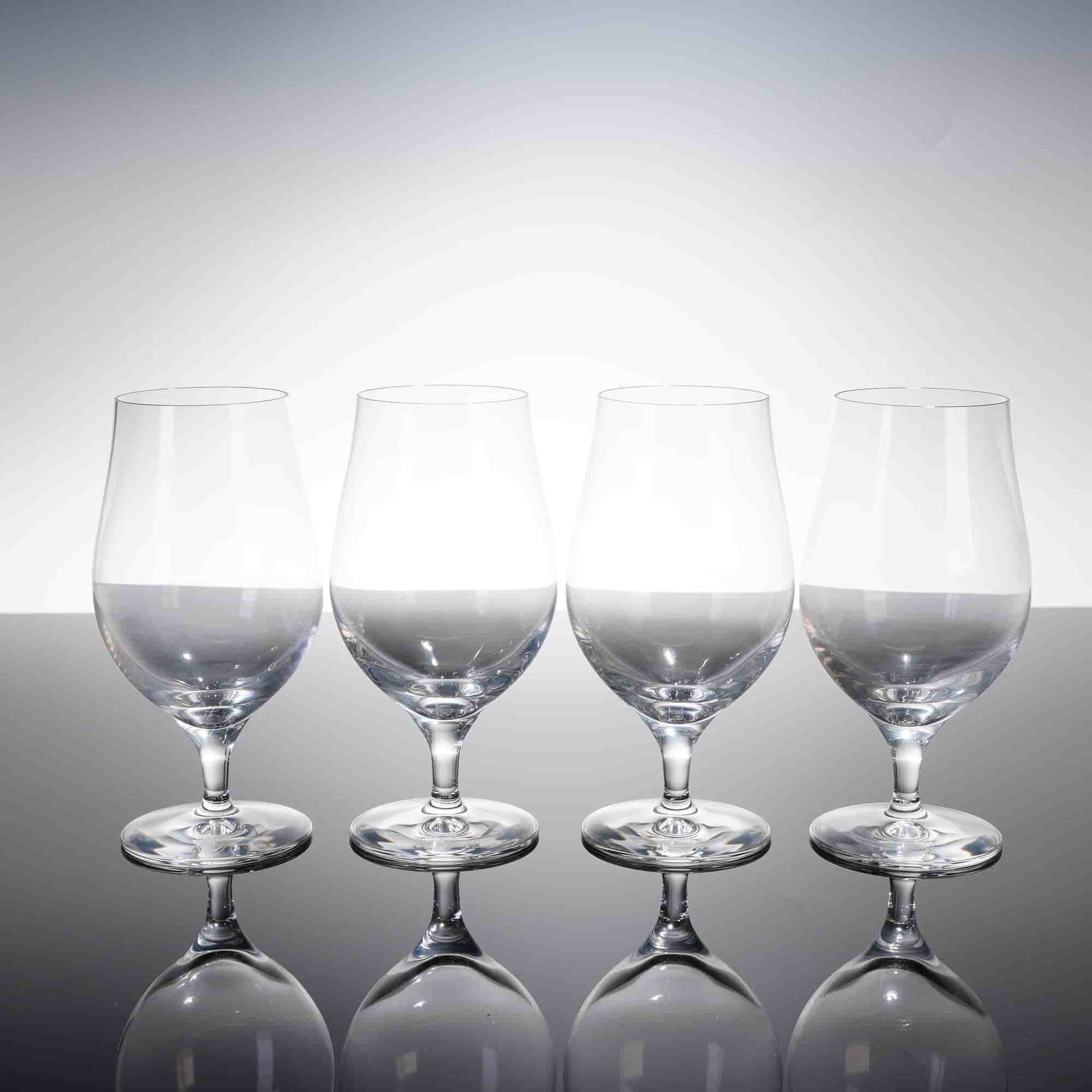 Collection of Four Orrefors Crystal Beer Taster Glasses: A collection of four Orrefors Beer Taster glasses, crafted from clear colorless crystal. The glasses feature a modernist design intended for optimal tasting of rich and full-bodied beers such as IPAs
