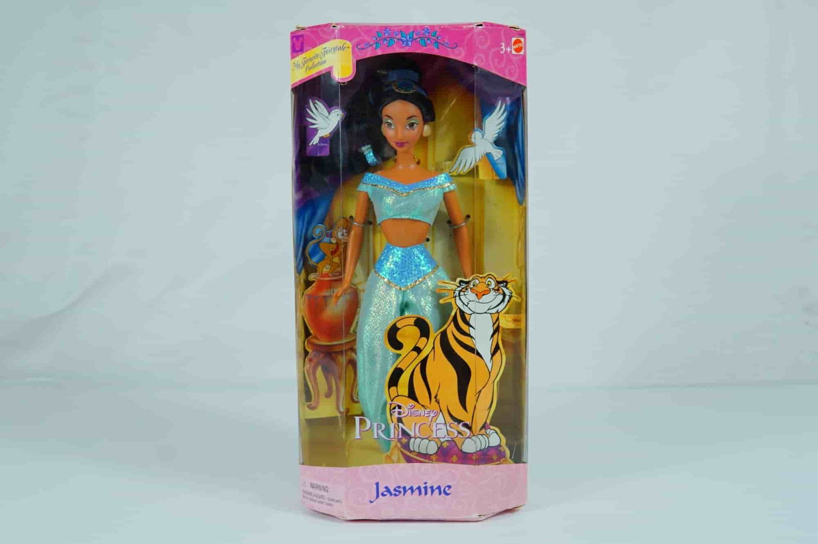 Mattel Disney Princess Jasmine My Favorite Fairytale Collection Doll, 12-inch: Produced by Mattel in 2000, this vinyl fashion doll represents Princess Jasmine from the Disney animated feature Aladdin as part of the My Favorite Fairytale Collection. The doll features articulated