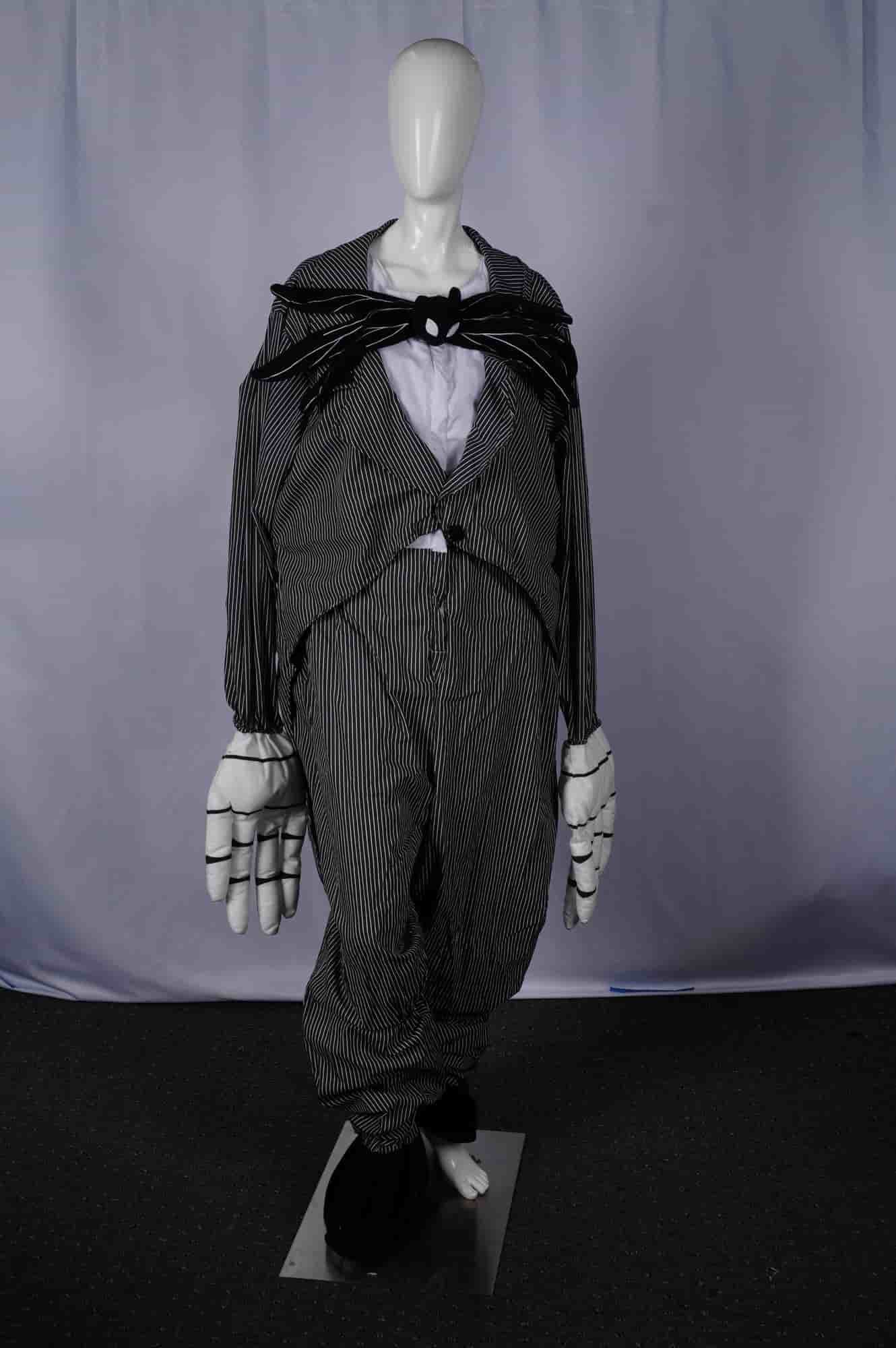 Disney Jack Skellington Nightmare Before Christmas Adult Costume, Size XL: A Disney Jack Skellington Nightmare Before Christmas adult costume. This full-body character costume is designed as a pinstriped suit in black and white, featuring a jacket with distinctive pointed ta