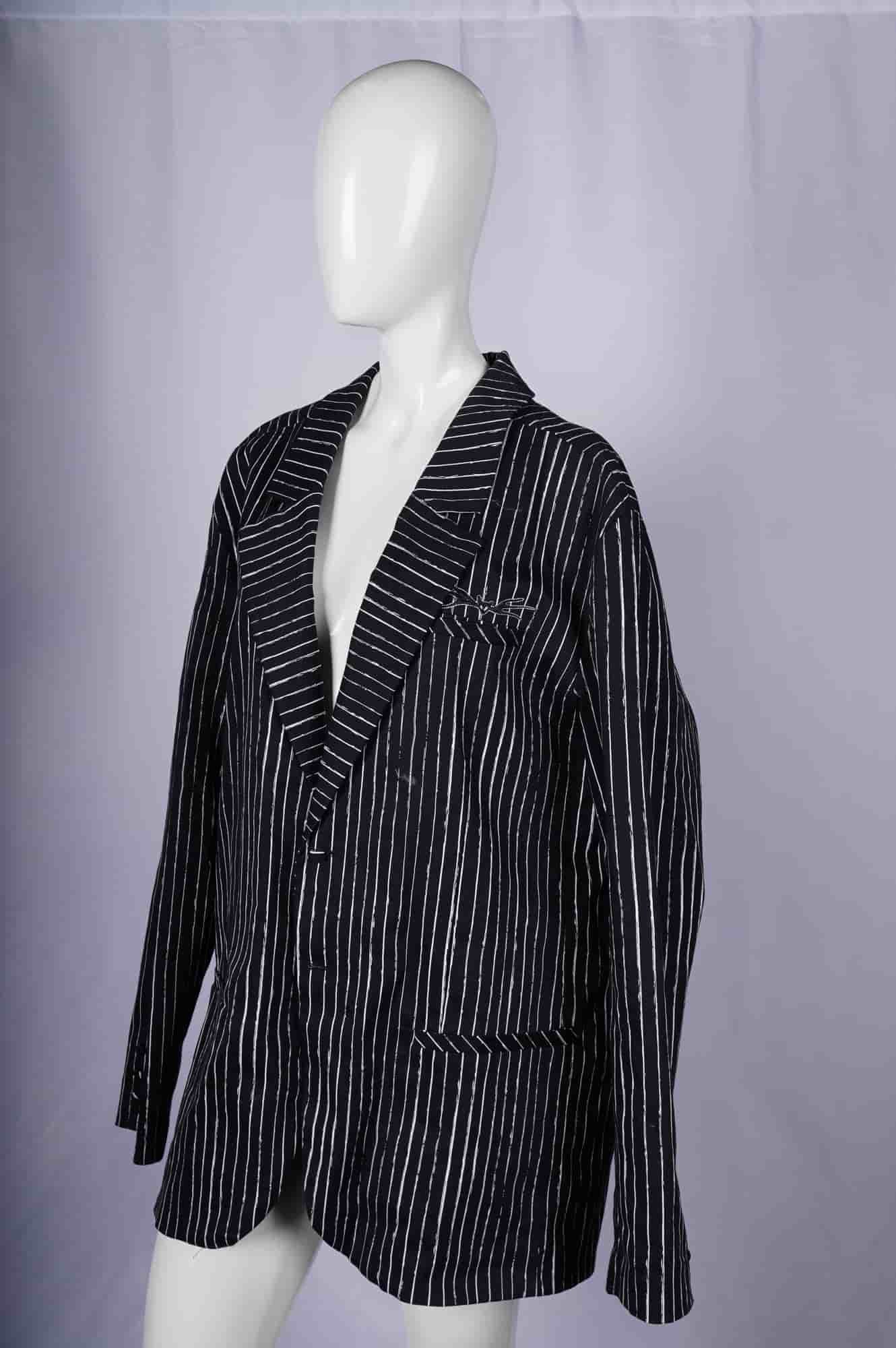 Disney Tim Burton The Nightmare Before Christmas Jack Skellington Jacket: A Disney Store jacket inspired by Tim Burton's The Nightmare Before Christmas, styled in Jack Skellington's signature black-and-white irregular pinstripes. This tailored piece features a notched lapel