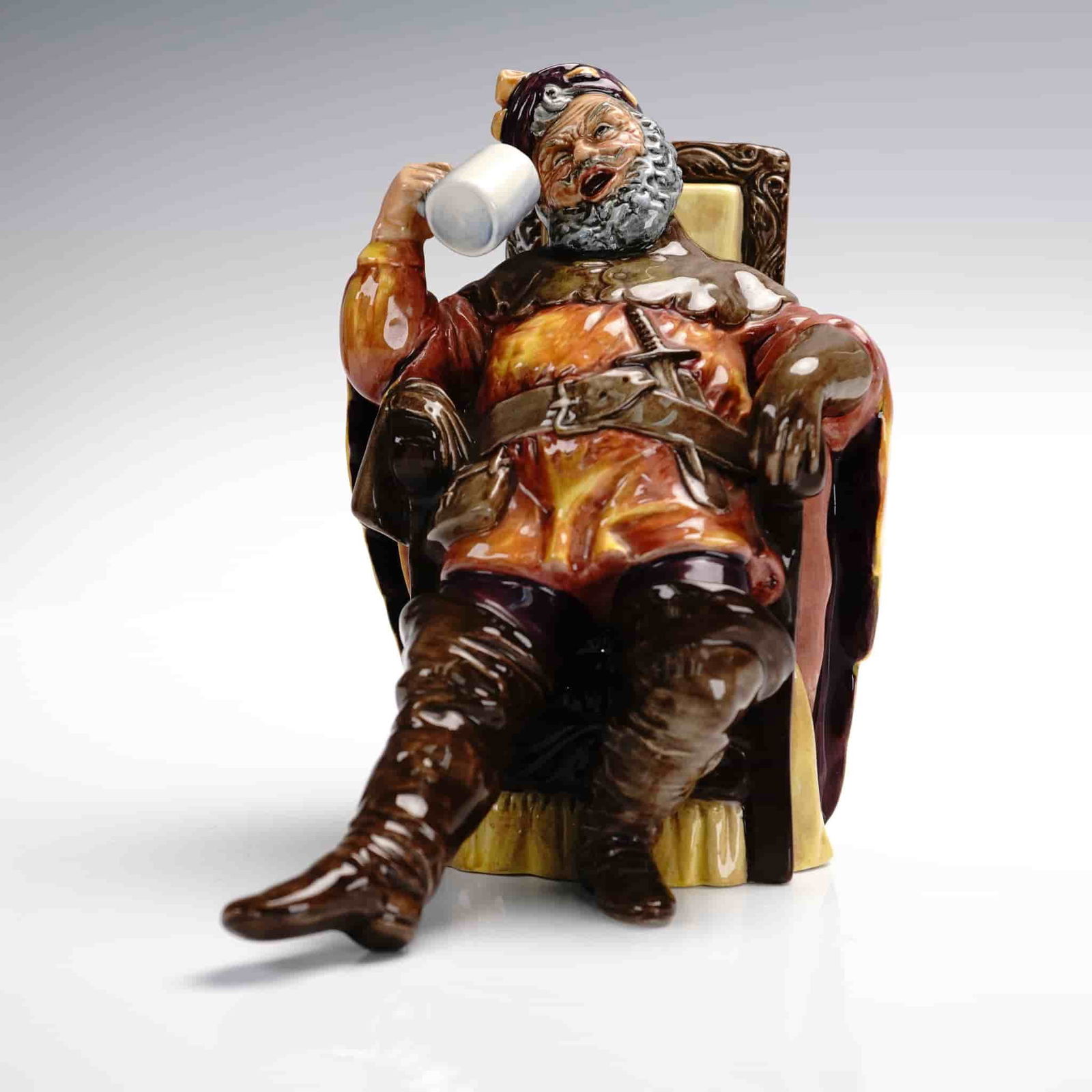 Royal Doulton Figurine, The Foaming Quart HN2162: Part of the Peggy Davies Classic group themed series. Features this fictional historical less than noble character in drunken stupor, drinking from a beer stein. Royal Doulton backstamp. ArtistPeggy D