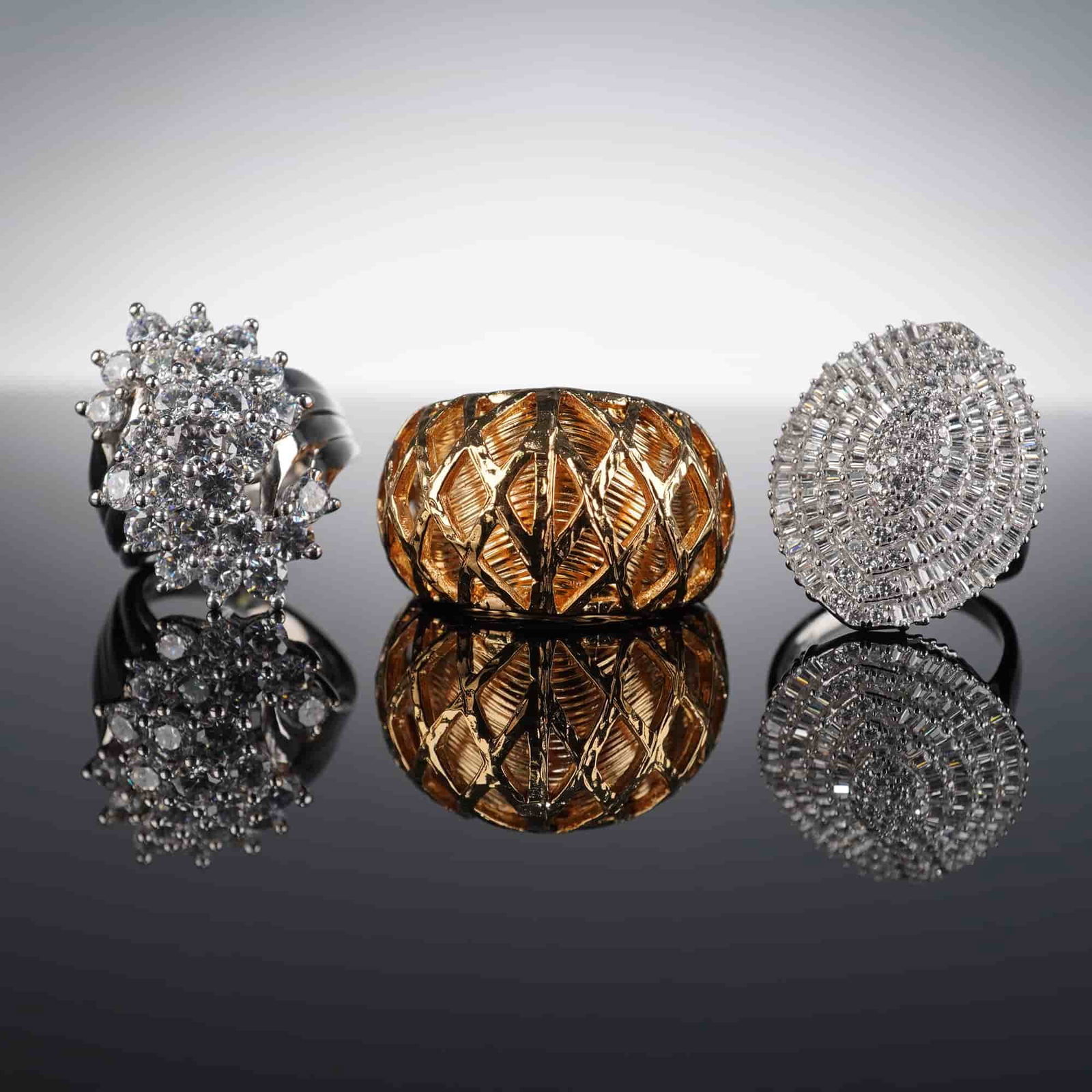 3pc Sterling Silver and 18K Gold Plated Rings: Group of three rings including two sterling silver examples and one gold-plated ring. The first silver ring, marked 925 CHINA, features alternating rows of baguette and round simulated stones in a cha