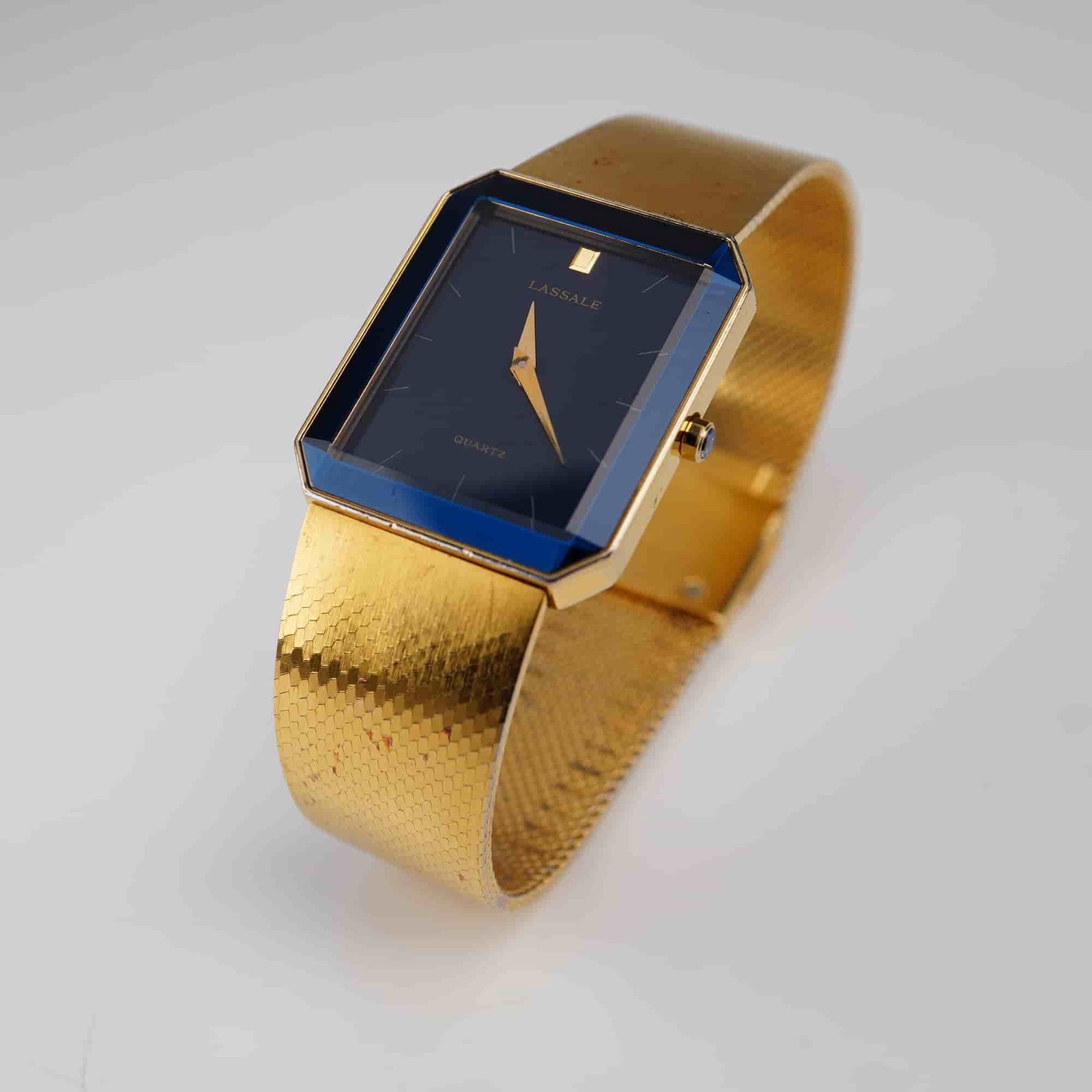 Seiko Lassale Quartz Blue and Gold Tone Wrist Watch: Quartz movement wristwatch featuring a rectangular blue and gold-tone base metal case with gold-tone hands. The case is signed "Lassale" and "Quartz." The case back is stamped "Base Metal 7N00-5039 03