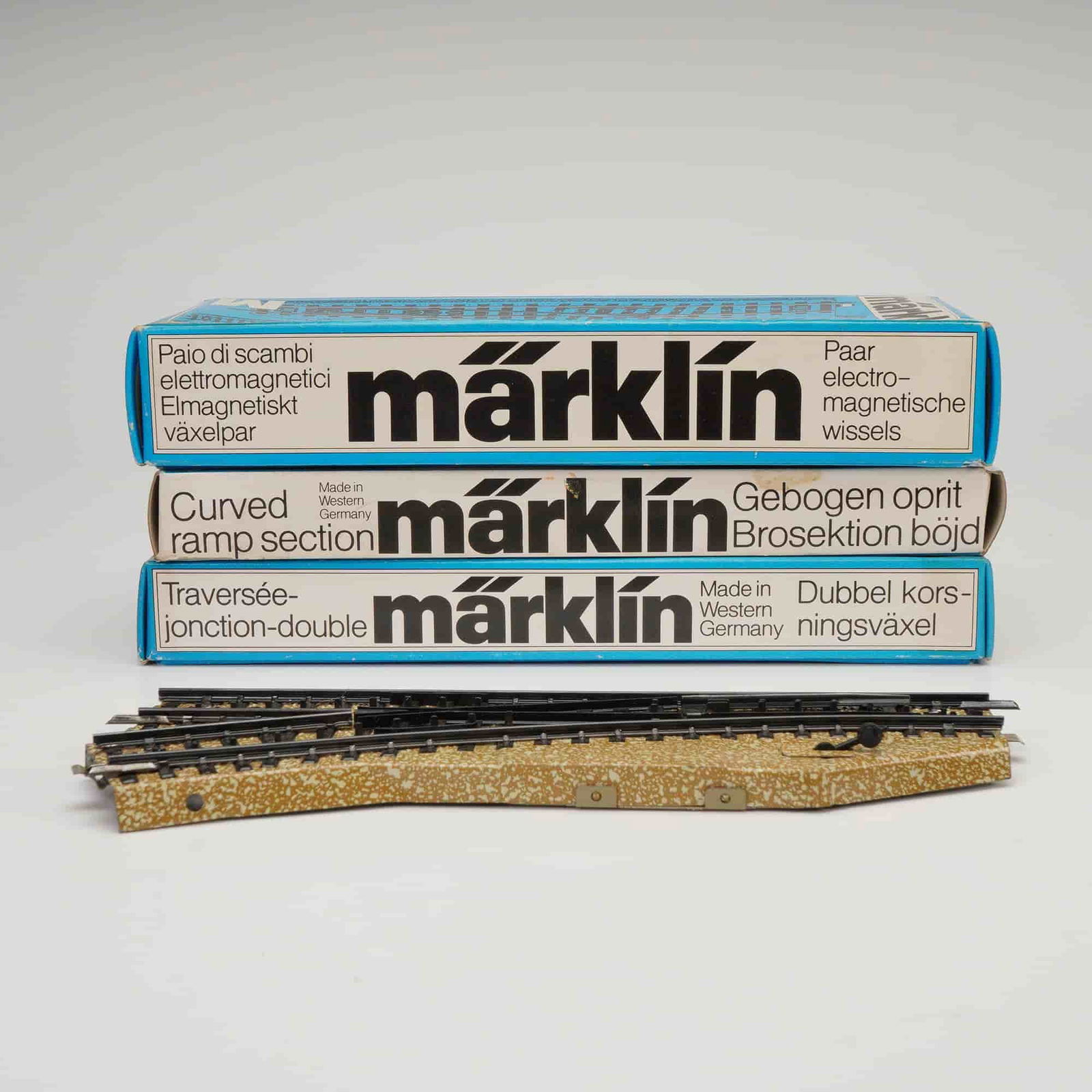 Collection of 15 Marklin H0 Scale Track Components with Original Packaging: This lot consists of 15 items of H0 scale model railroad track components and associated original packaging manufactured by Marklin. The components are primarily identified as M-Track and K-Track