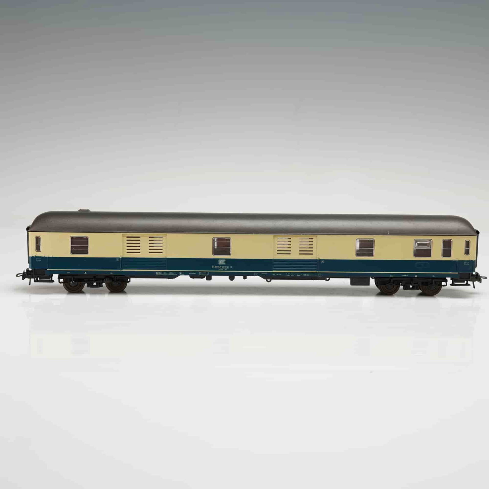 Roco HO Scale Passenger Car Model 4259: This Roco HO scale model 4259 features a detailed passenger car with a tan and blue color scheme. The car includes finely molded components and is marked Made in Austria on the underside,