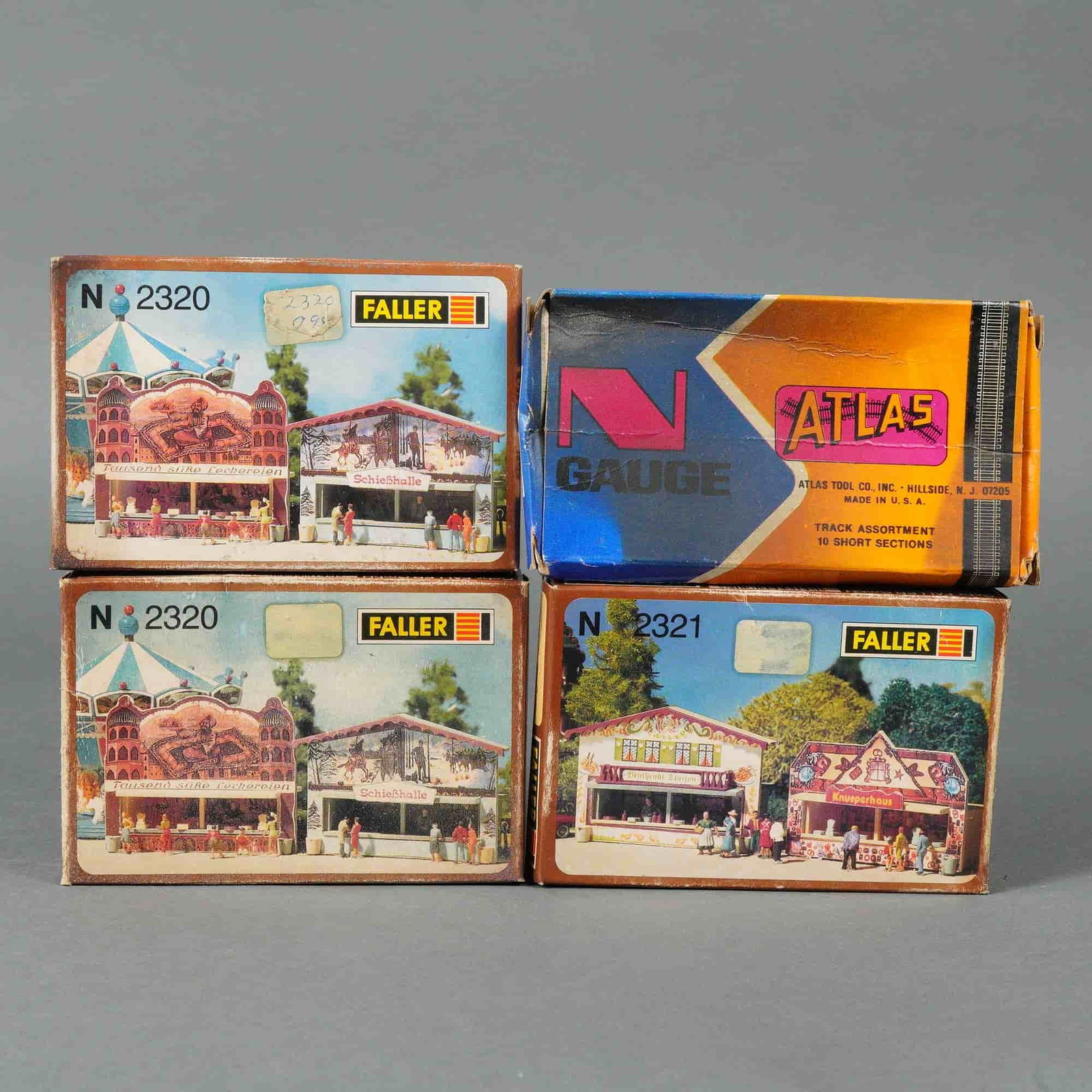 A Group of Faller and Atlas N-Gauge Model Kits: A group of four N-gauge model kits, comprising one Atlas N Gauge Track Assortment and three Faller N-gauge model kits. The Atlas kit, marked "N GAUGE" and "MADE IN U.S.A.," is a "TRACK ASSORTMENT" of