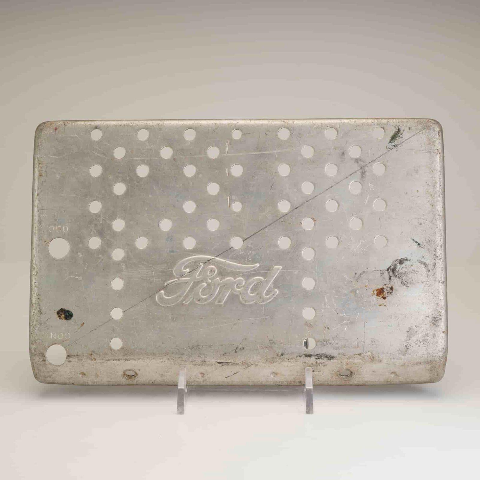 Ford Perforated Radio Top Cover, 1942-1948 Ford and Mercury: Manufacturer: Ford. Part Number: Stamped 030 and CONX. Type: Perforated radio top cover. Compatibility: 1942-1948 Ford and Mercury automotive radio units. This original Ford perforated top cover