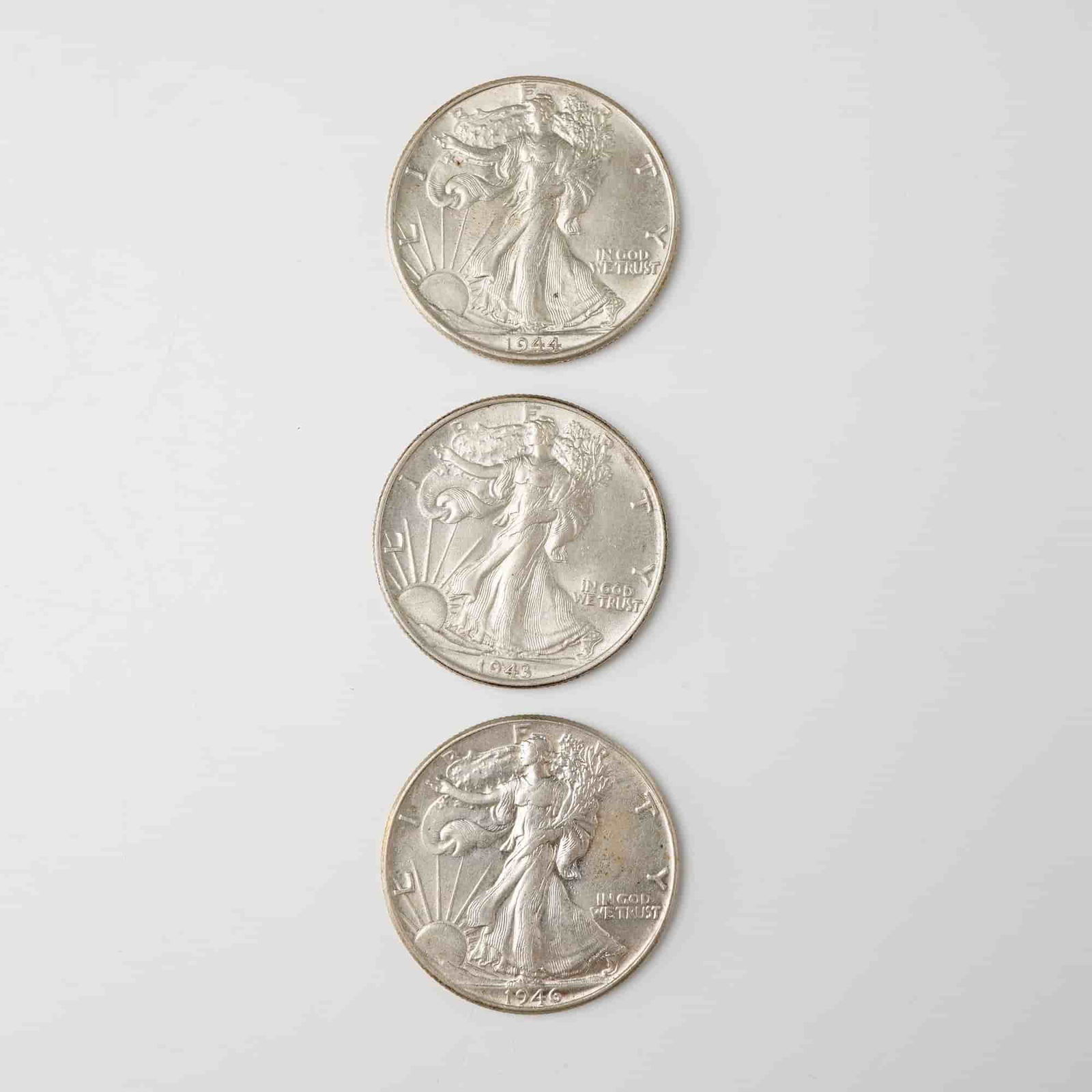 3pc 1943 to 1946 Walking Liberty Silver Half Dollars: Each struck with a composition of 90 percent silver containing approximately 0.3617 troy ounces of silver per coin. The obverse depicts Liberty striding toward the rising sun with the inscriptions