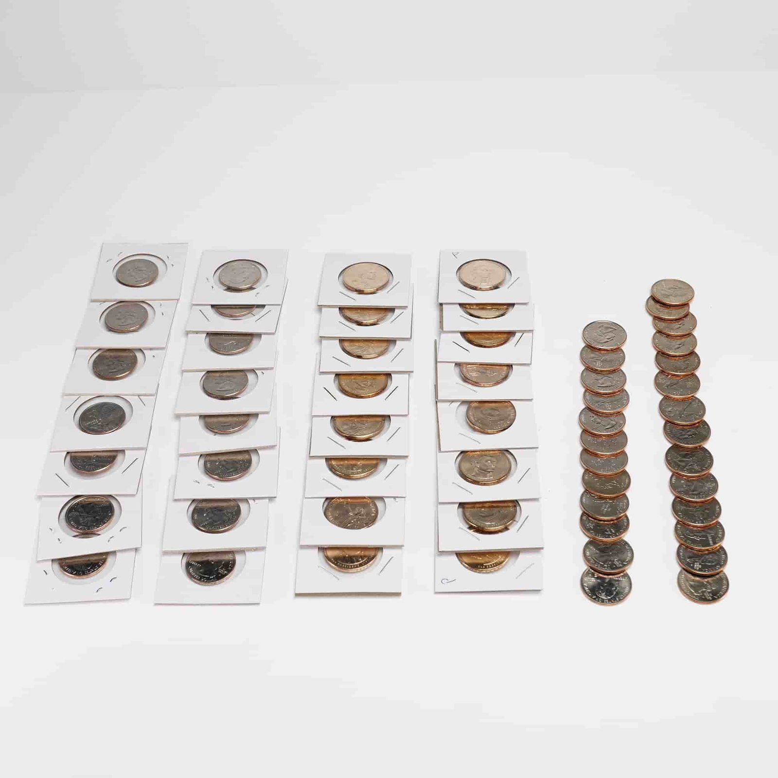 Large Collection of US 1999-2009 Statehood Quarters and Presidential Dollars: A collection of 50 plus coins comprising US Statehood and Territory quarters and manganese-brass dollar coins. The assembly includes various dates and mint marks from the 50 State Quarters Program