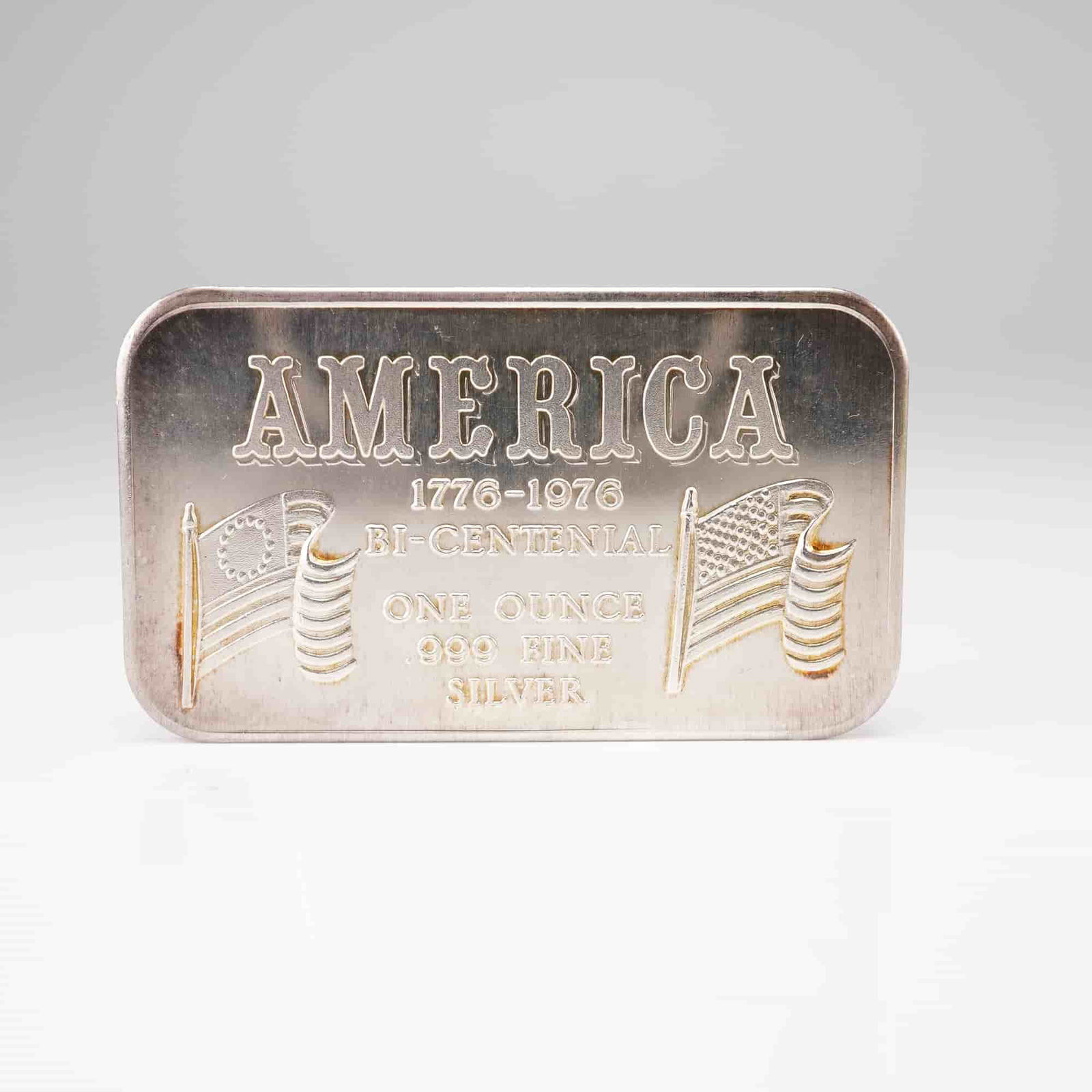 Silver 1 oz t .999 Fine, Fortune Mint, American Bicentennial 1776-1976: This commemorative silver bullion bar is struck in 1 troy ounce (31.1035 grams) of .999 fine silver. Based on market consensus, this piece is attributed to the Fortune Mint. The design commemorates