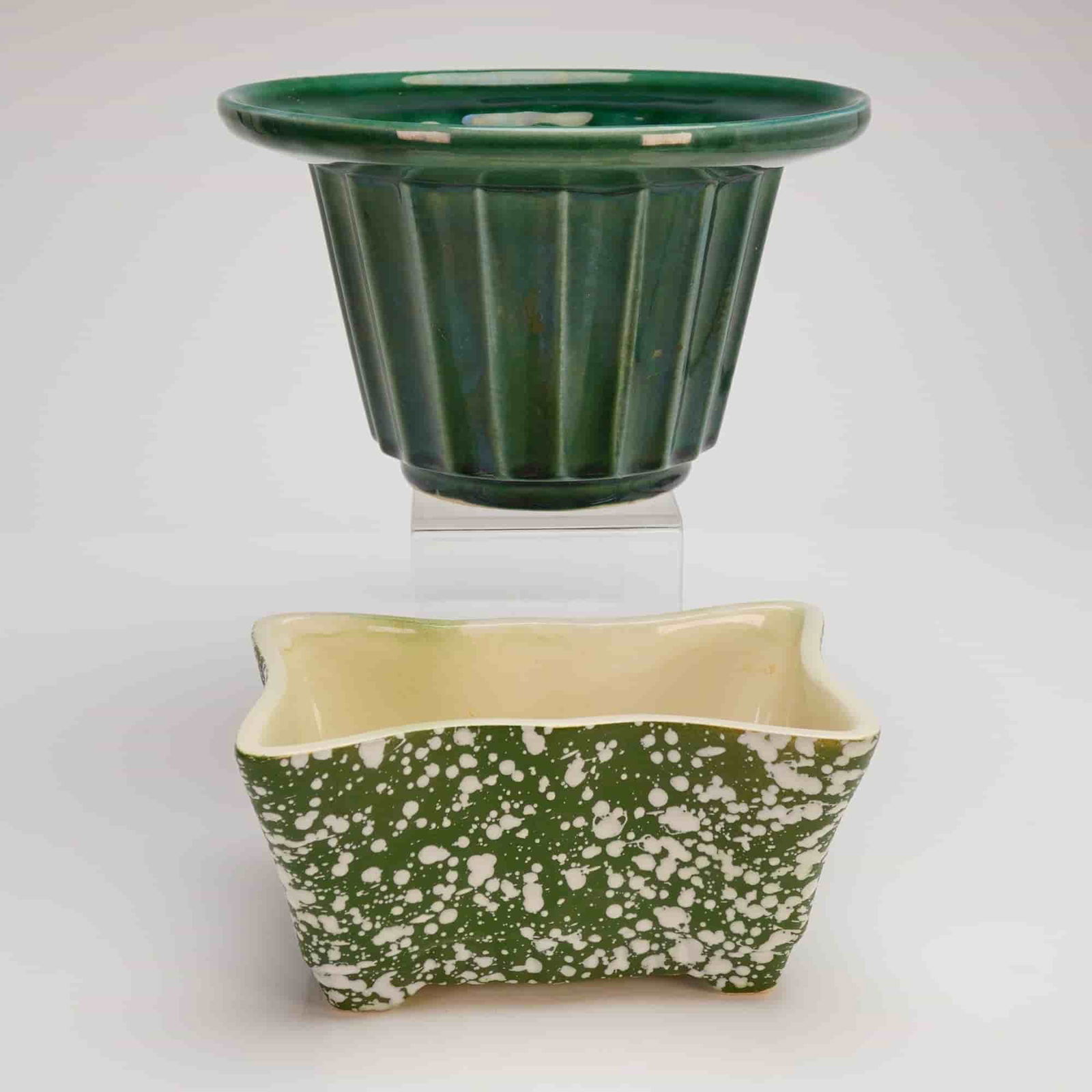 A Pair of Mid-Century Modern American Art Pottery Planters Marked USA: A pair of American ceramic planters exhibiting Mid-Century Modern (MCM) art pottery styling, circa 1950s. The lot consists of two pieces. The first item is a circular bulb planter or decorative bowl