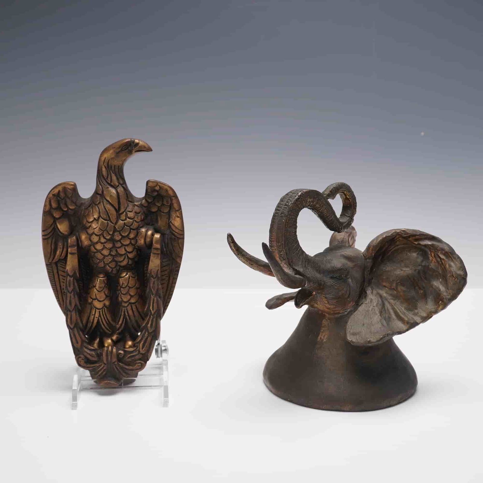 2pc Cast Metal Carl Wagner Elephant Bell and Eagle Doorknocker: A group of two cast metal decorative objects. The first is an elephant-form bell, the head and trunk forming the handle, signed Carl Wagner and dated 1978, editioned 329/500. Wagner (1938-2011) was an