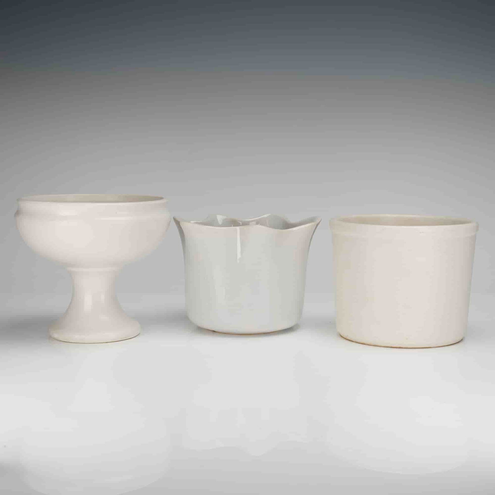 A Trio of McCoy Floraline White Ceramic Planters and Containers: A collection of three (3pc) white ceramic planters and storage containers from the McCoy Pottery Floraline design series. This group consists of three distinct forms, all finished in an off-white or c