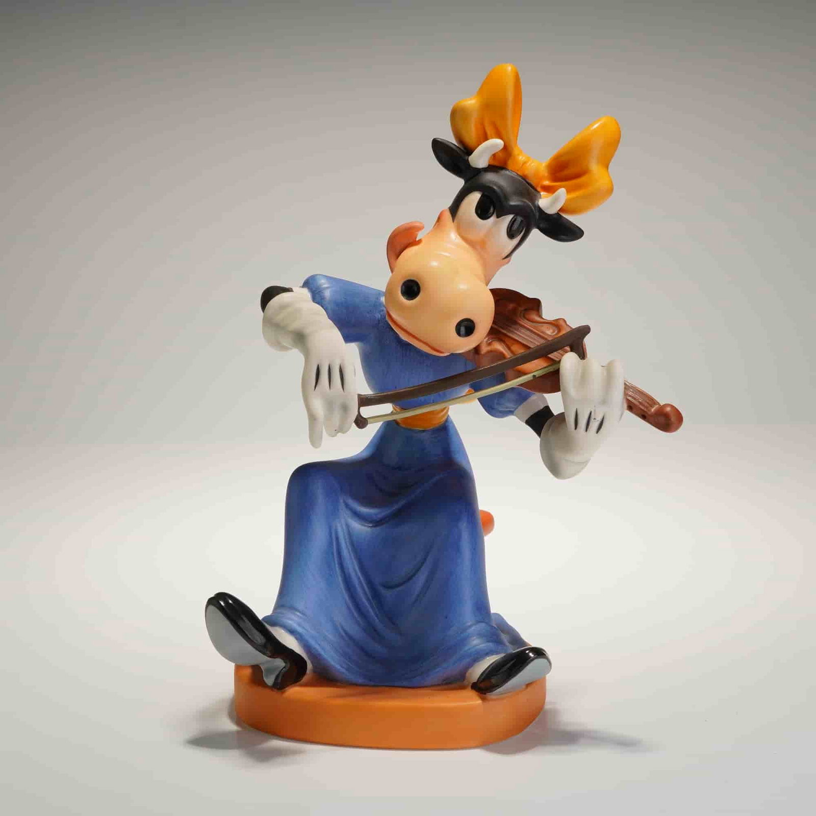 Walt Disney Classics Collection Clarabelle Crescendo Figurine w/ COA: A Walt Disney Classics Collection (WDCC) figurine featuring the character Clarabelle Cow titled Clarabelle's Crescendo from the Symphony Hour collection. The main ceramic figurine depicts Clarabelle C