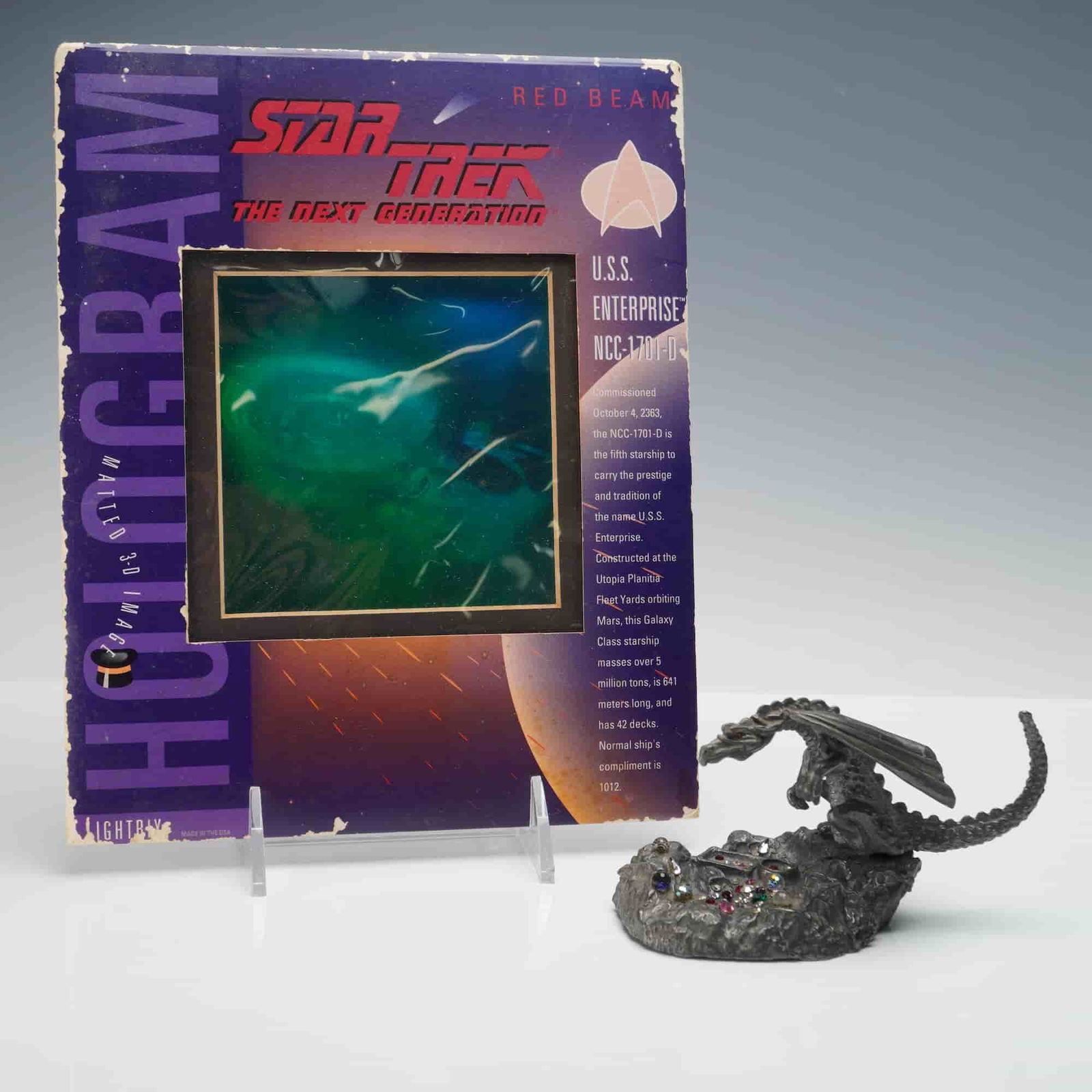 2pc Traumwelt & Paramount Pictures Dragon Figurine & Red Beam Hologram: 2pc Traumwelt & Paramount Pictures Pop Culture Collectibles. The lot includes a "Star Trek: The Next Generation" U.S.S. Enterprise NCC-1701-D Red Beam hologram display, produced under license by