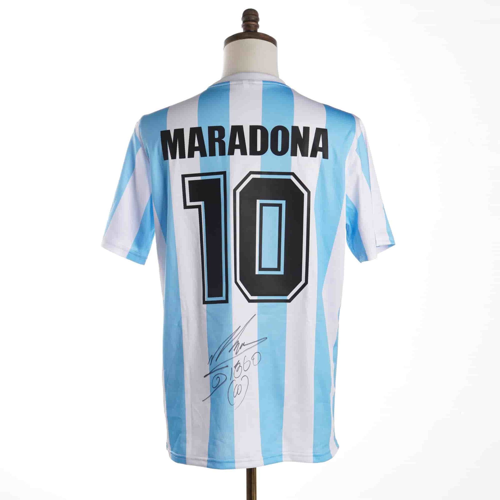 Diego Maradona Signed 1986 Argentina National Team Jersey w/ COA: An autographed Argentina National Team replica home soccer jersey based on the 1986 model year. The garment features light blue and white vertical stripes with the Argentine Football Association